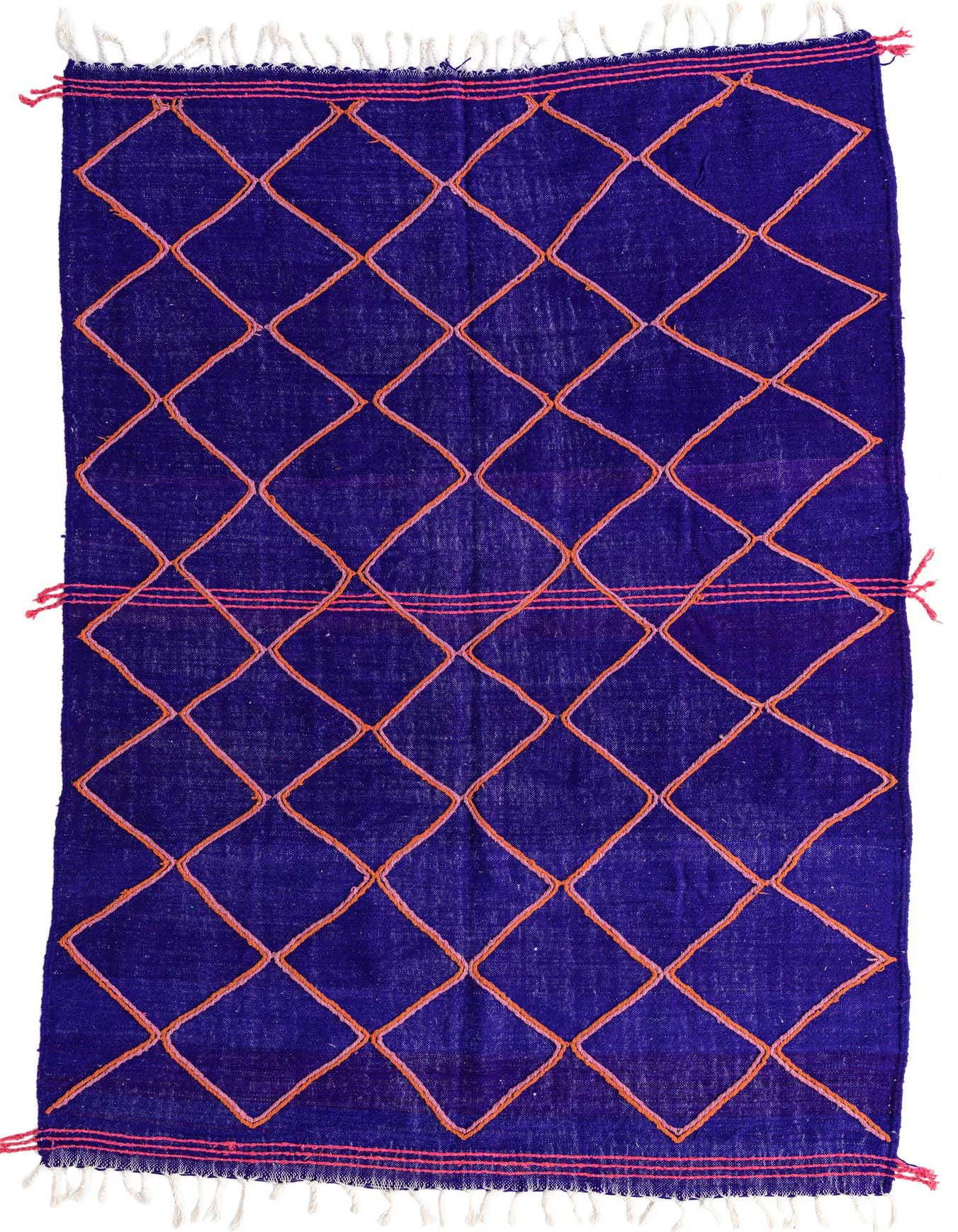 A 7x10 rectangular purple shag rug with an orange diamond tribal pattern, featuring white fringes.