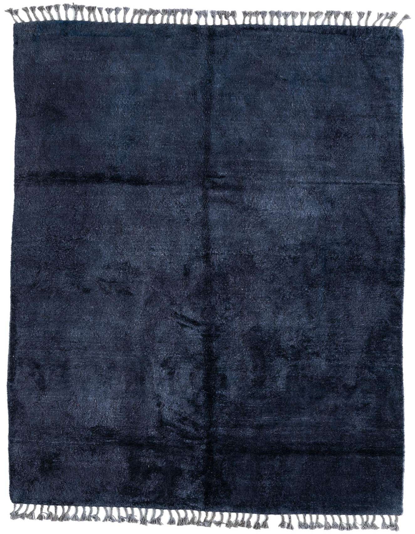 A 6x9 rectangular purple shag rug with a solid color and grey tassels on both ends, suitable for a living room.