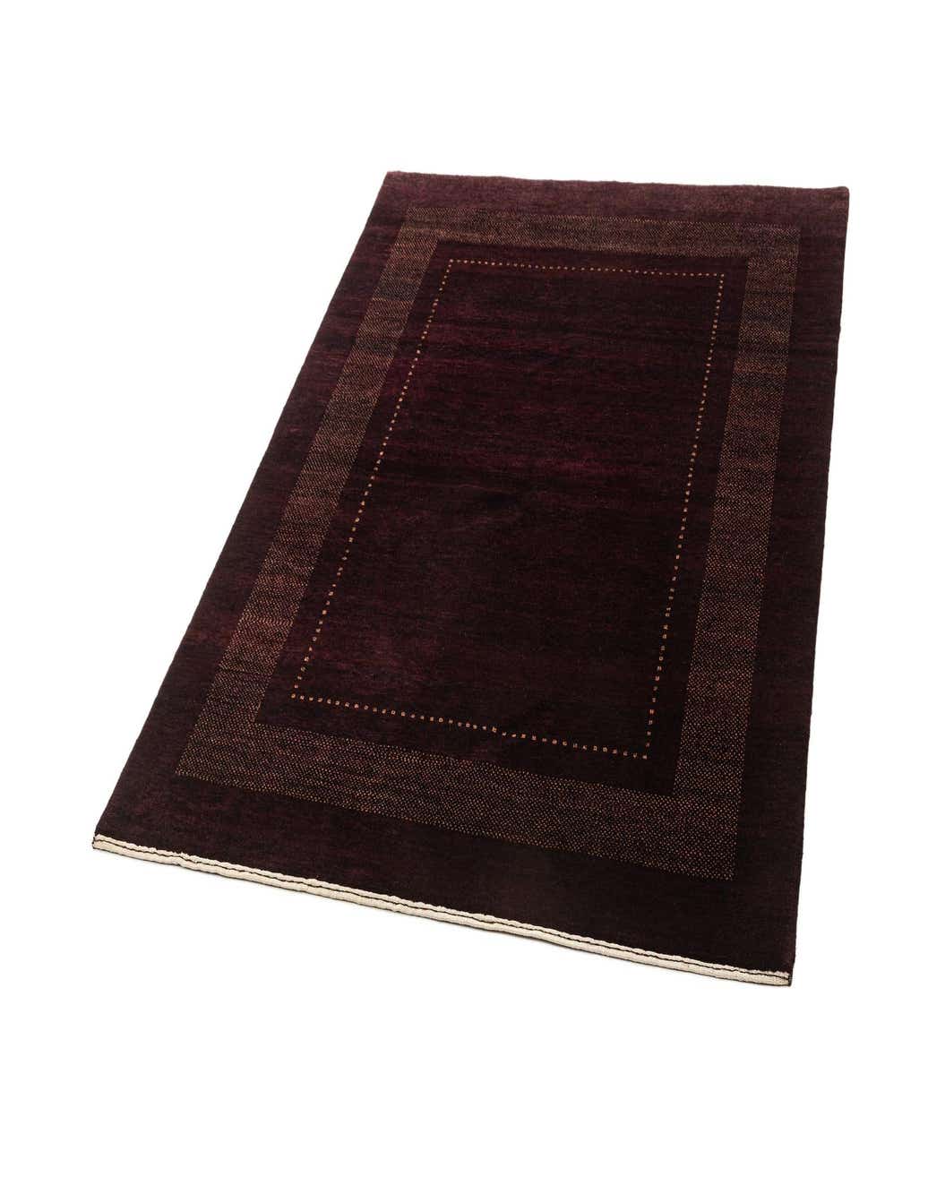 A 4x6 rectangular Sonaghuly wool rug in deep purple with a subtle lighter purple border, handmade for indoor spaces.