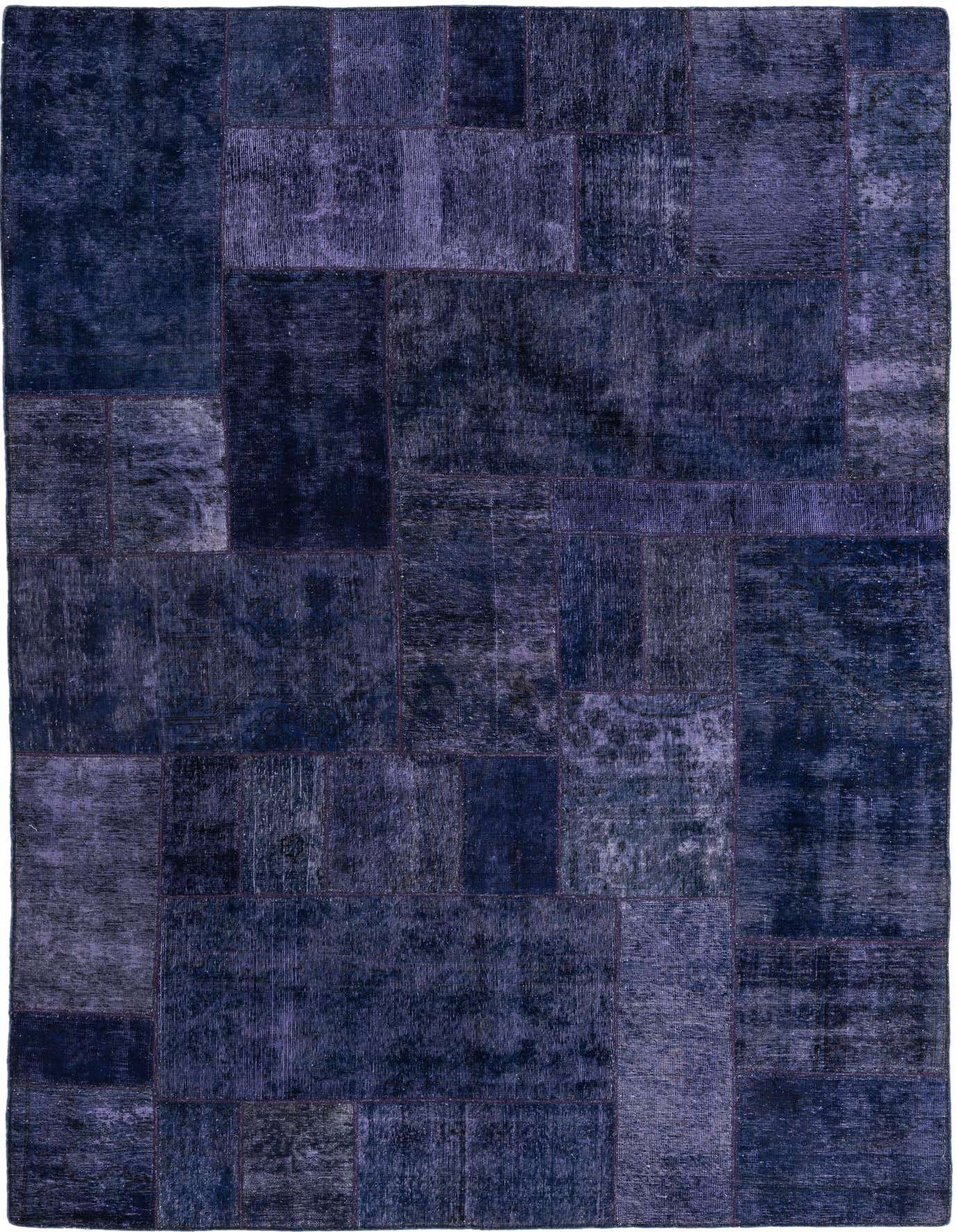 A 7x10 rectangular Ultra Vintage rug featuring a patchwork design in various shades of purple, made from 100% wool.