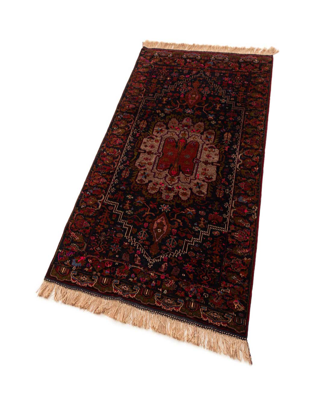 A 4x6 rectangular Afghan tribal rug in deep reds and dark tones, featuring a central medallion and intricate patterns, with fringed ends.