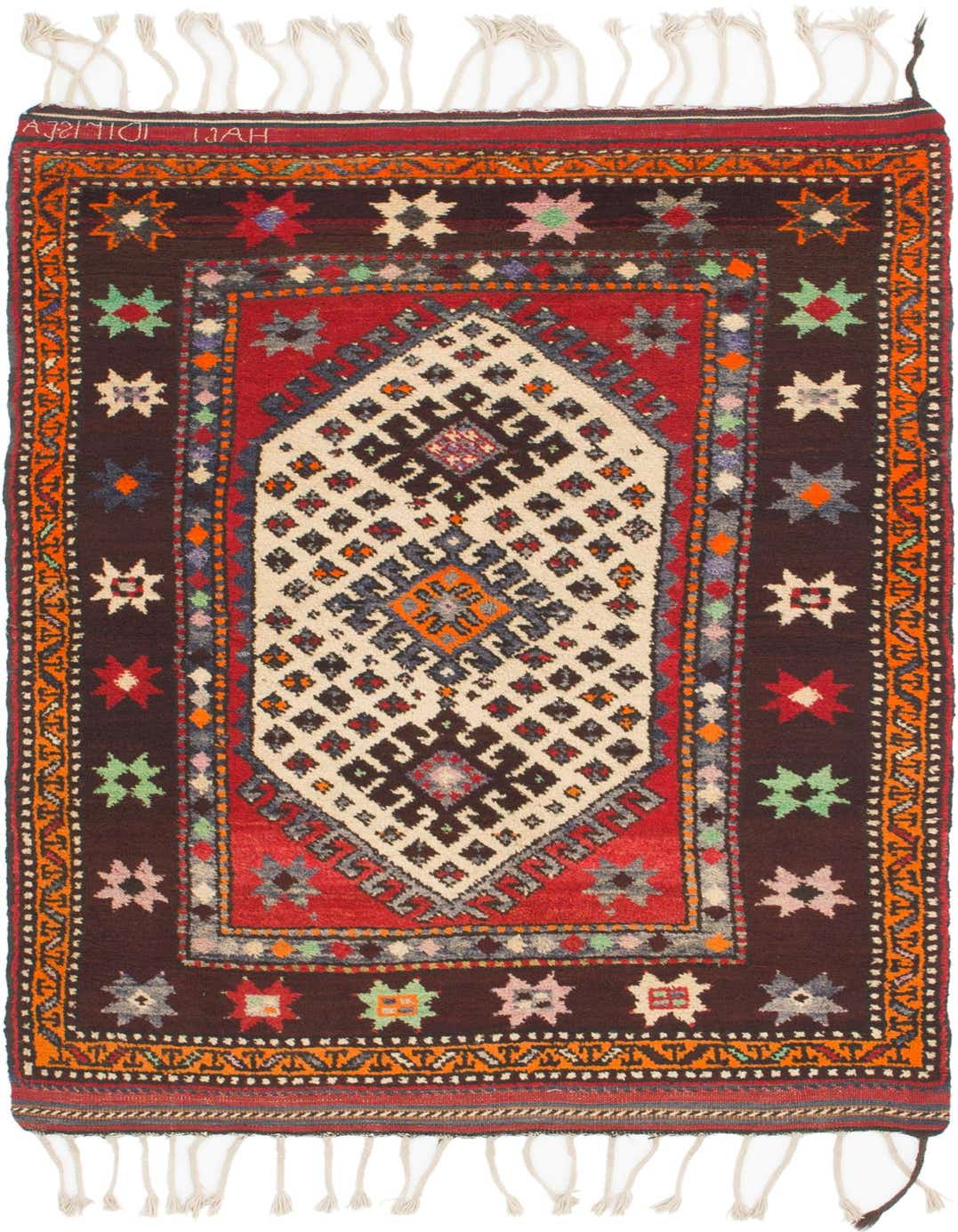 A 4x6 rectangular Anatolian wool rug with a central medallion, featuring reds, browns, and multi-colored tribal patterns, suitable for a living room.