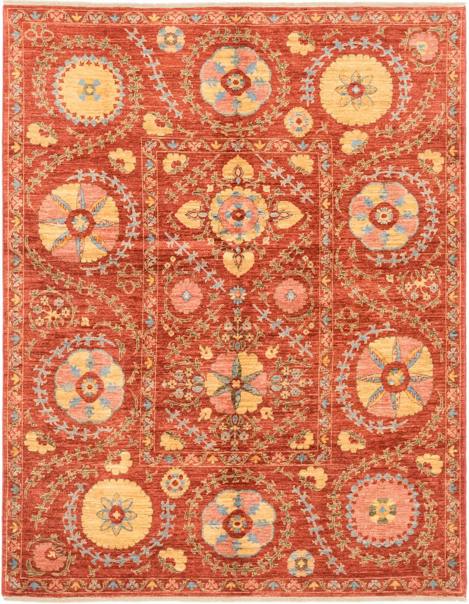 A 5x7 rectangular Ariana Ziegler rug featuring a traditional tribal pattern in shades of red, gold, blue, and pink.