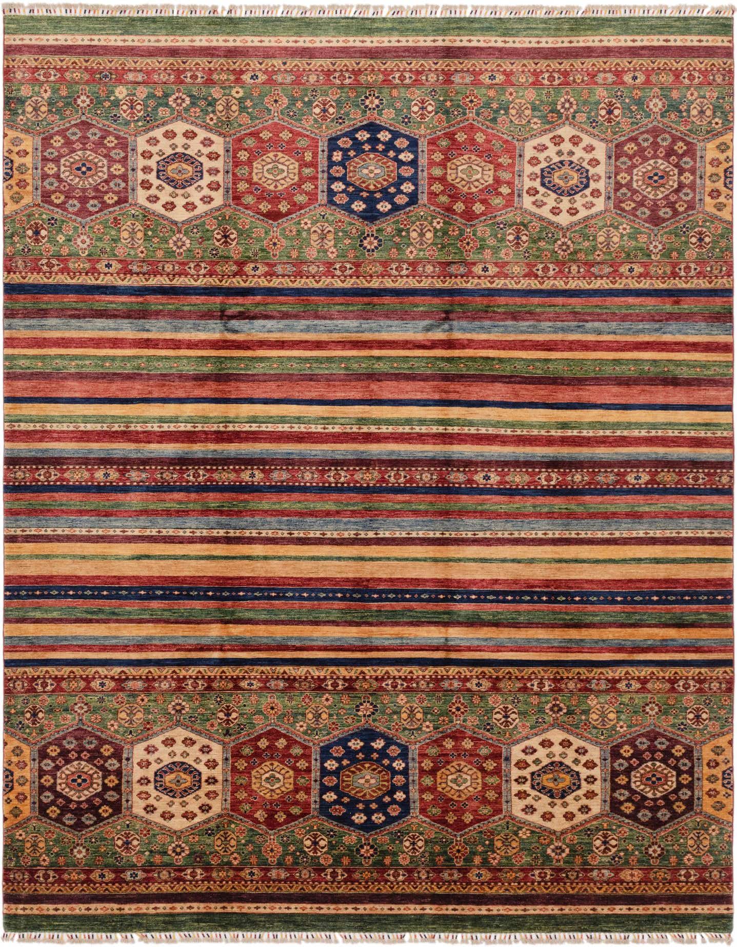 A 9x12 rectangular Ariana Ziegler rug featuring a vibrant Southwestern tribal pattern with red, green, blue, and gold stripes, and intricate hexagonal medallions.