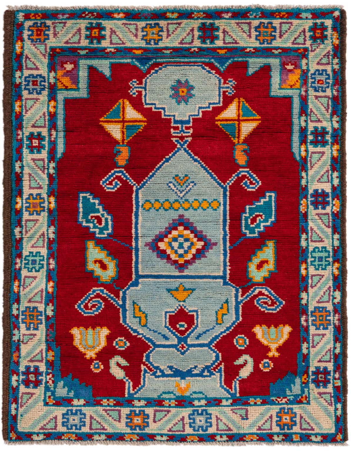 A 3x4 rectangular Balouch rug with a deep red field and a light blue central medallion, featuring intricate Southwestern and tribal patterns in blue, yellow, and orange.
