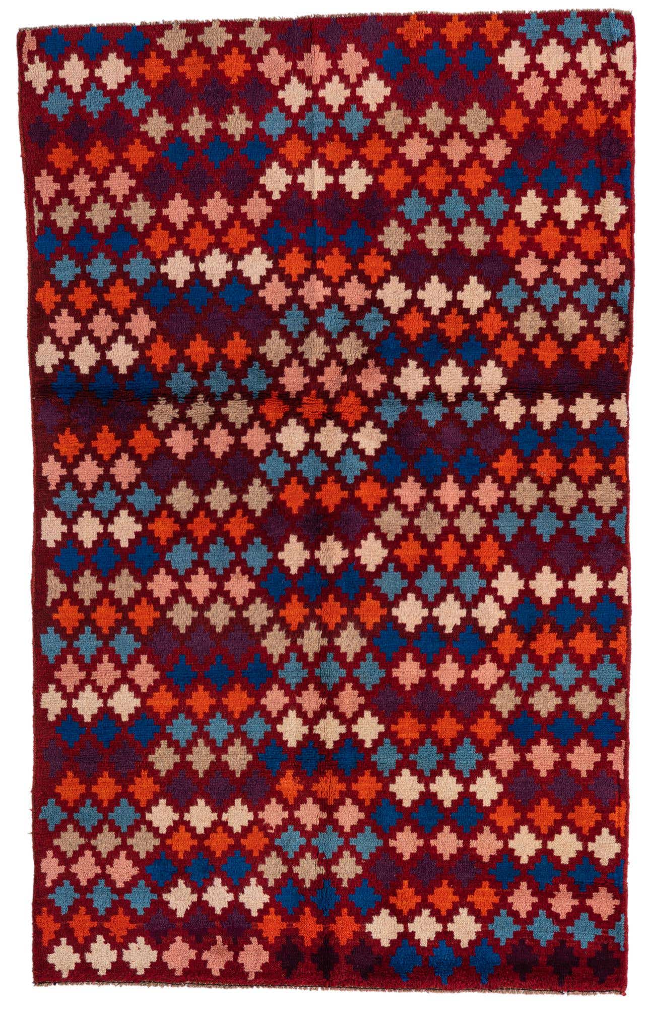 A 4x6 rectangular Balouch rug with a traditional tribal pattern in various shades of red, blue, orange, and cream.