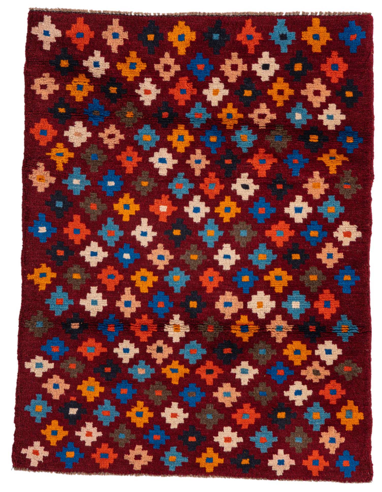 A 3x4 rectangular Balouch rug with a deep red background and a repeating pattern of colorful tribal motifs in blue, orange, yellow, and cream.