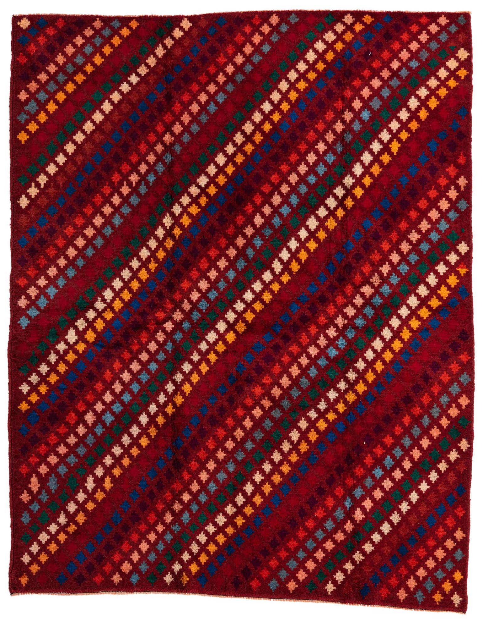 A 5x7 rectangular Balouch rug with a deep red background and diagonal rows of colorful small geometric patterns in blue, green, orange, and cream.