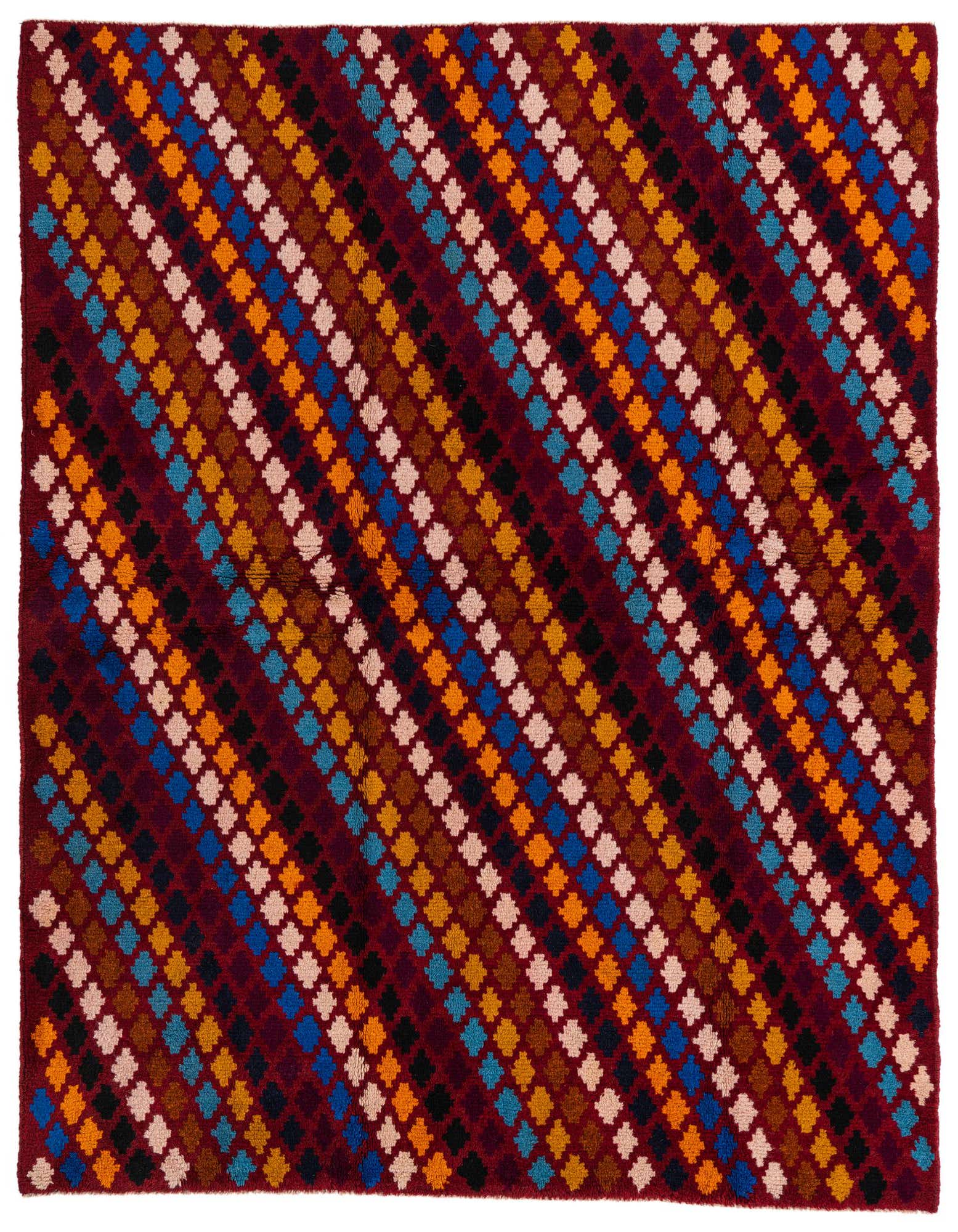 A 5x8 rectangular Balouch rug with a deep red background and diagonal rows of colorful tribal diamond patterns in blue, orange, yellow, black, and beige.