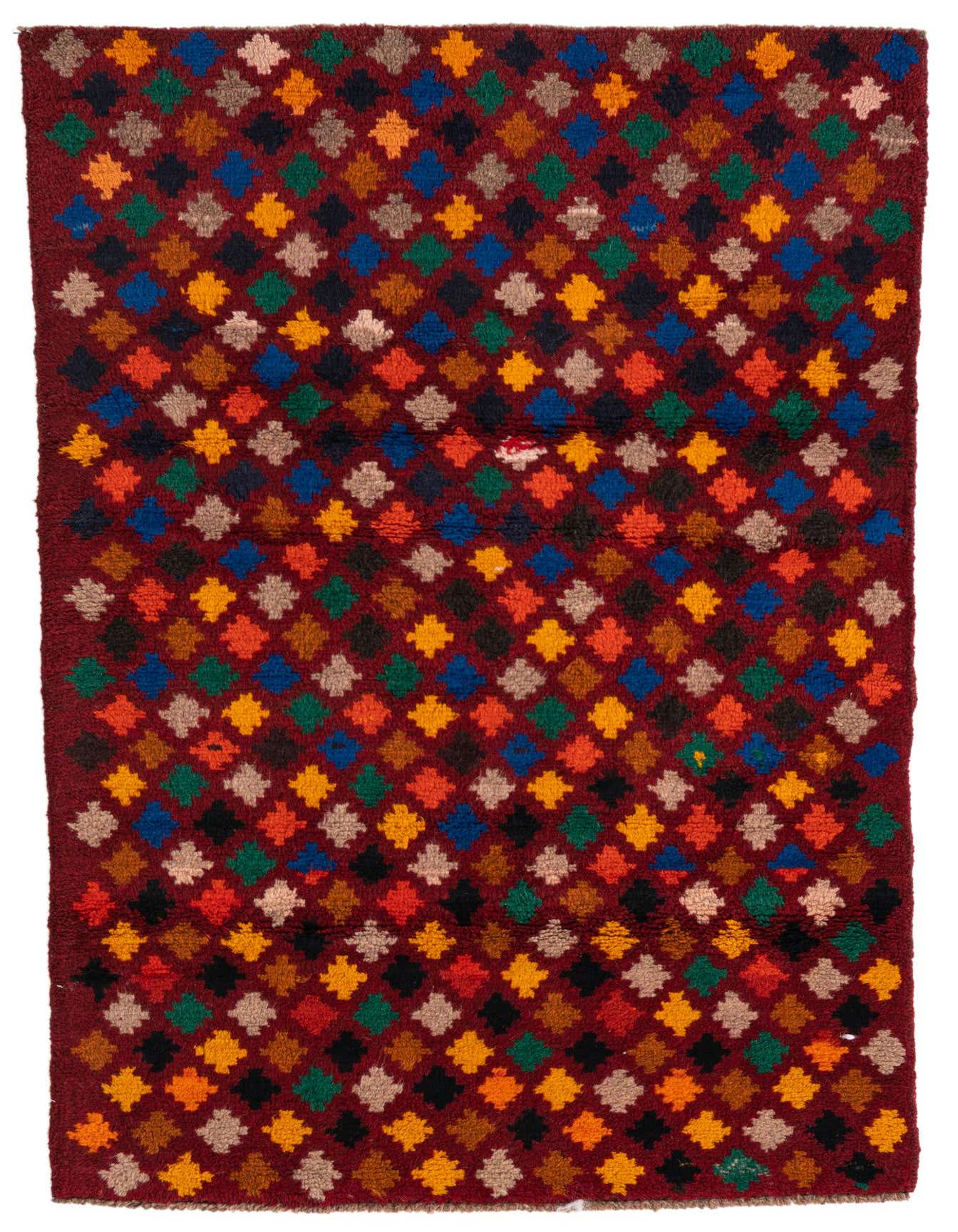 A 3x5 rectangular Balouch rug with a tribal, abstract pattern of colorful diamonds on a deep red background.