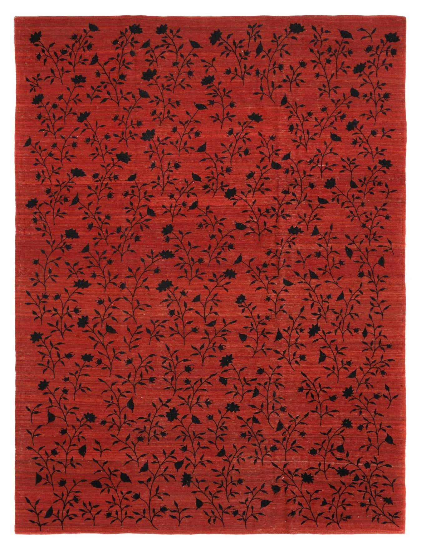 A 7x10 rectangular red wool rug with an all-over black floral and vine pattern, suitable for a living room.