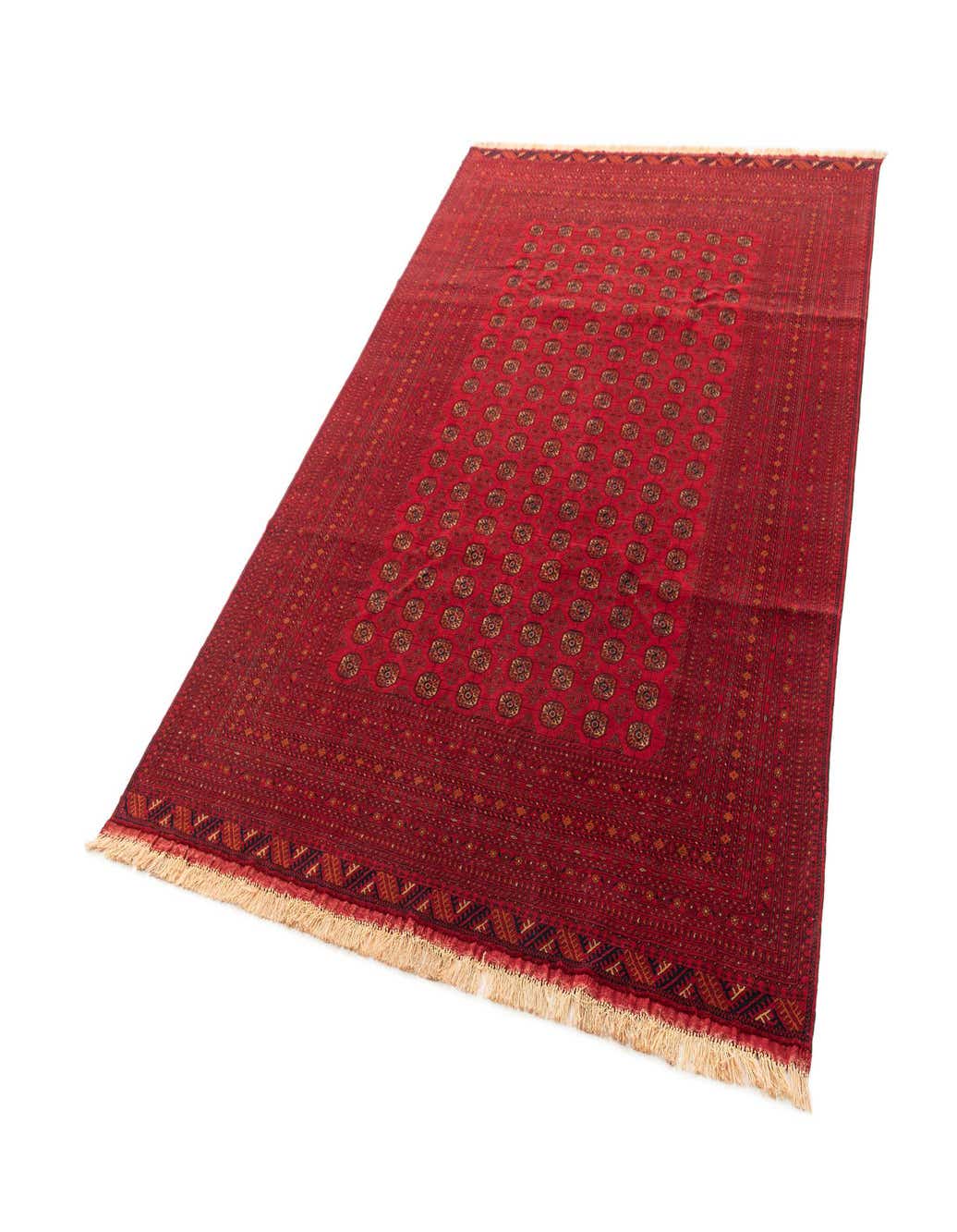 A 6x9 rectangular red area rug with a traditional repeating pattern and fringed edges, suitable for a living room.