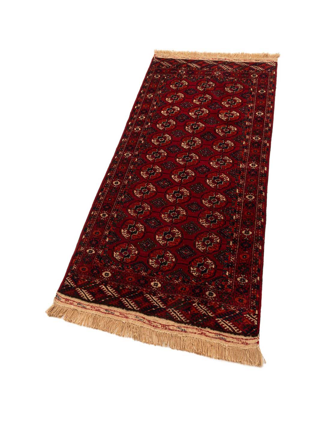 A 4x6 rectangular red tribal rug with intricate patterns and fringe, made from sheep virgin wool.