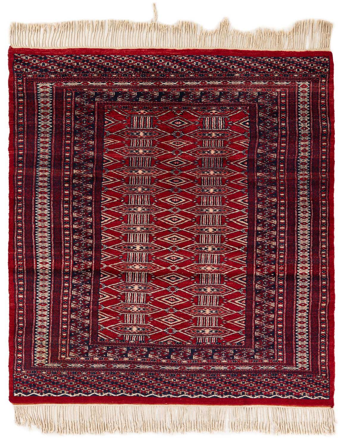 A 4x6 rectangular red wool rug with traditional tribal patterns and cream fringes, suitable for a living room.