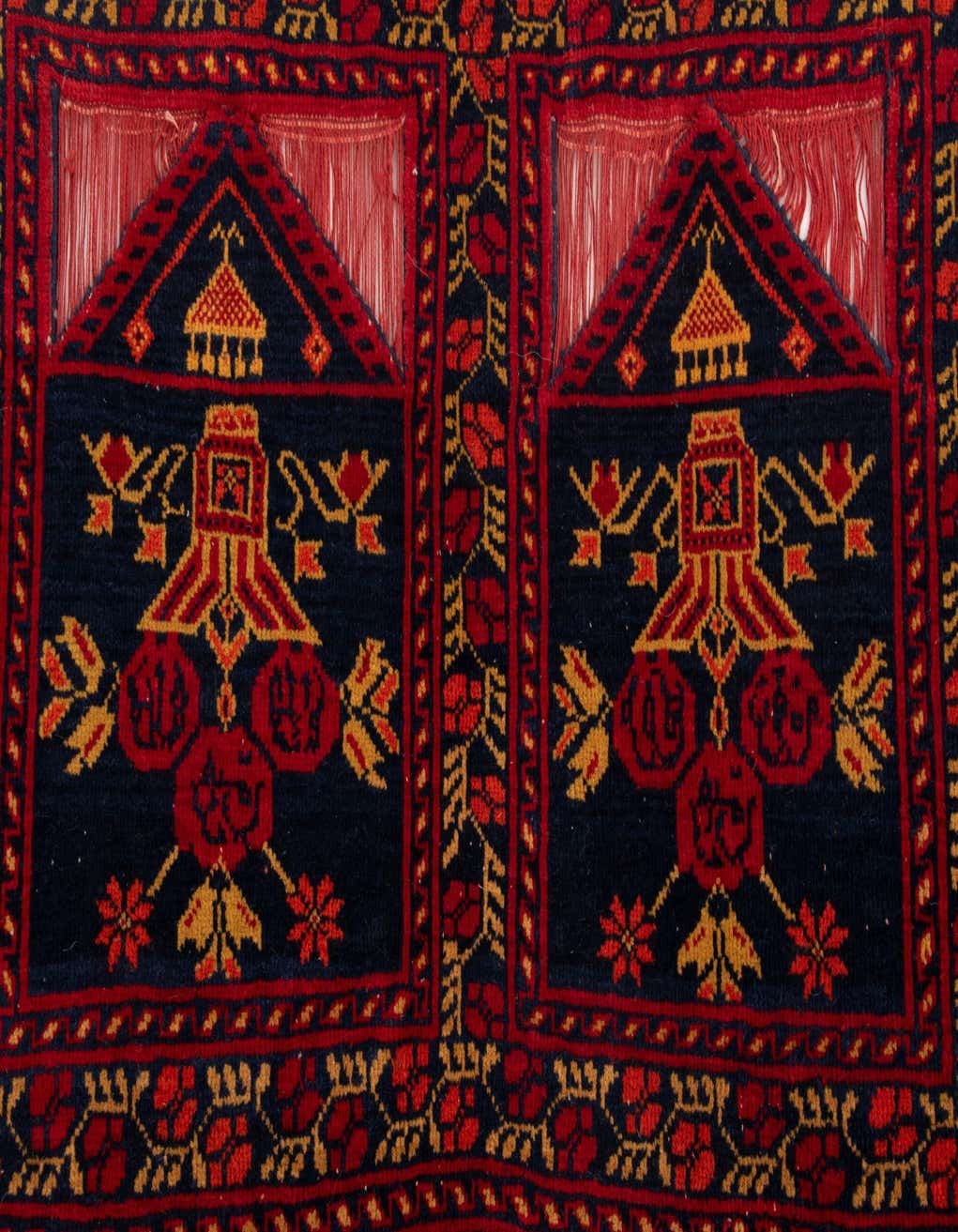 A close-up of a Jaler 5 Ft Runner rug, showcasing its intricate red and navy Persian pattern with gold accents and a medium pile.