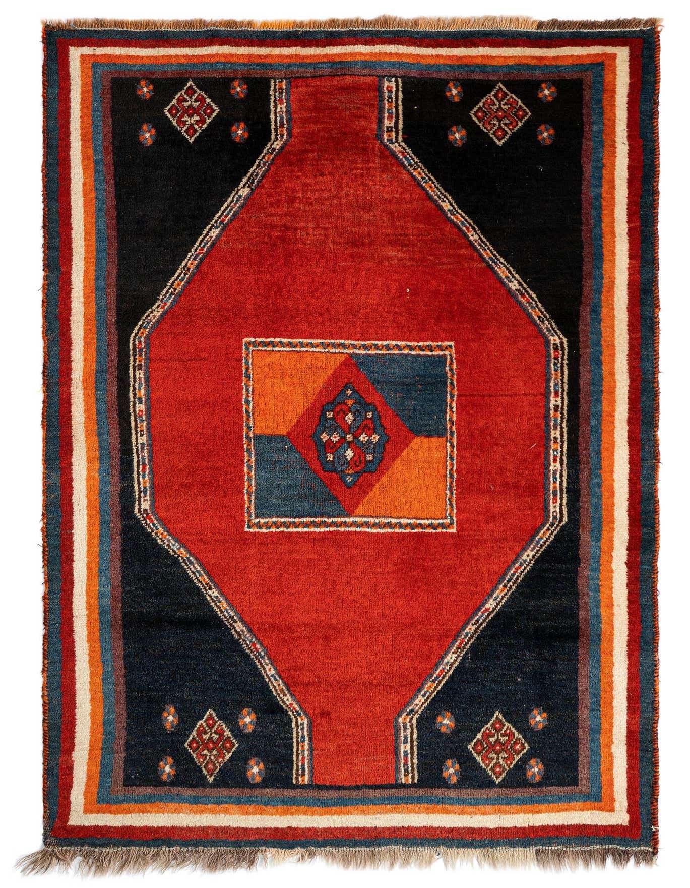 A 3x5 rectangular Gabbeh rug featuring a bold red center diamond with a blue and orange square, bordered by dark blue and striped edges.