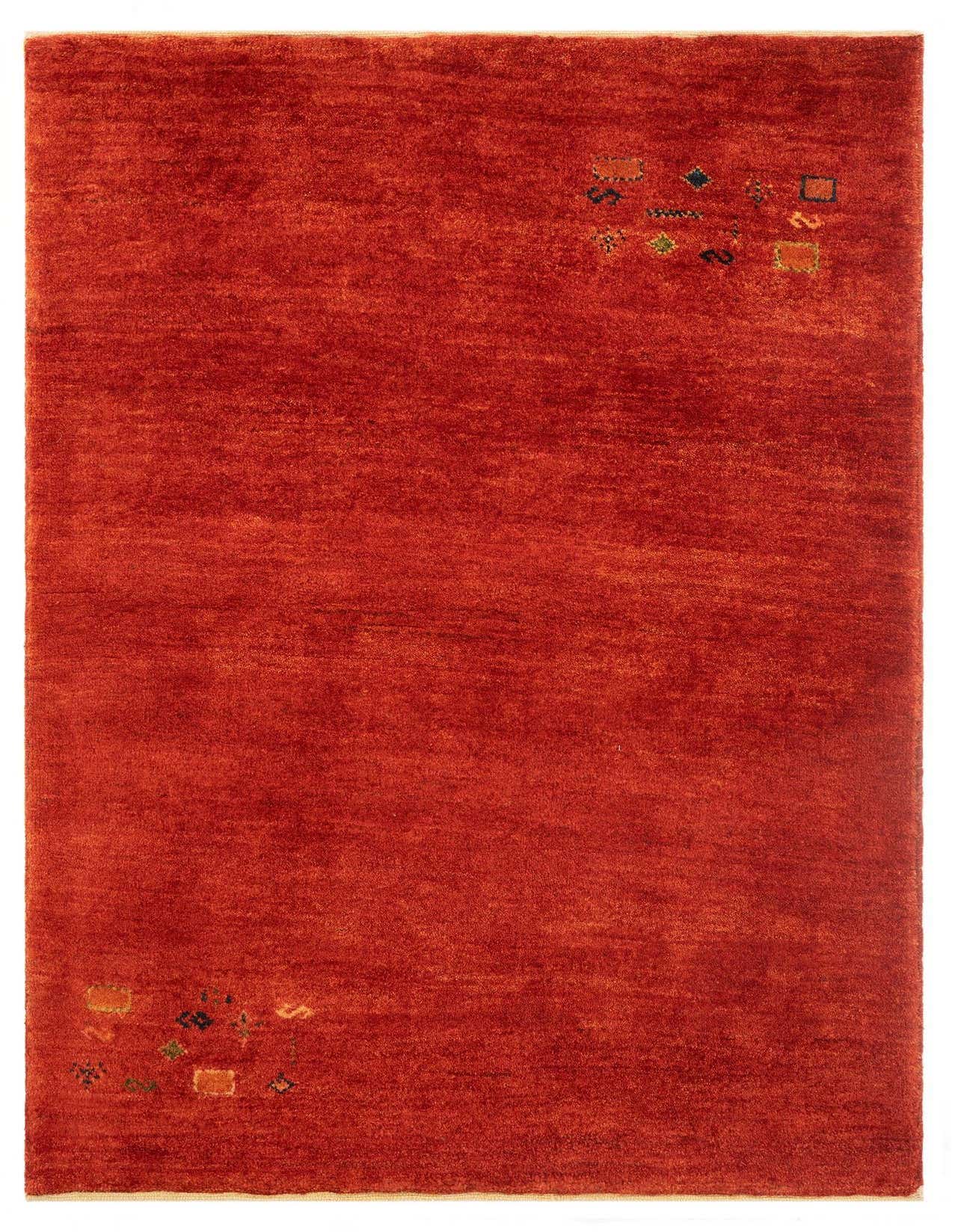 A 3x5 rectangular red Gabbeh rug with a medium pile and subtle multi-color geometric accents in the corners.