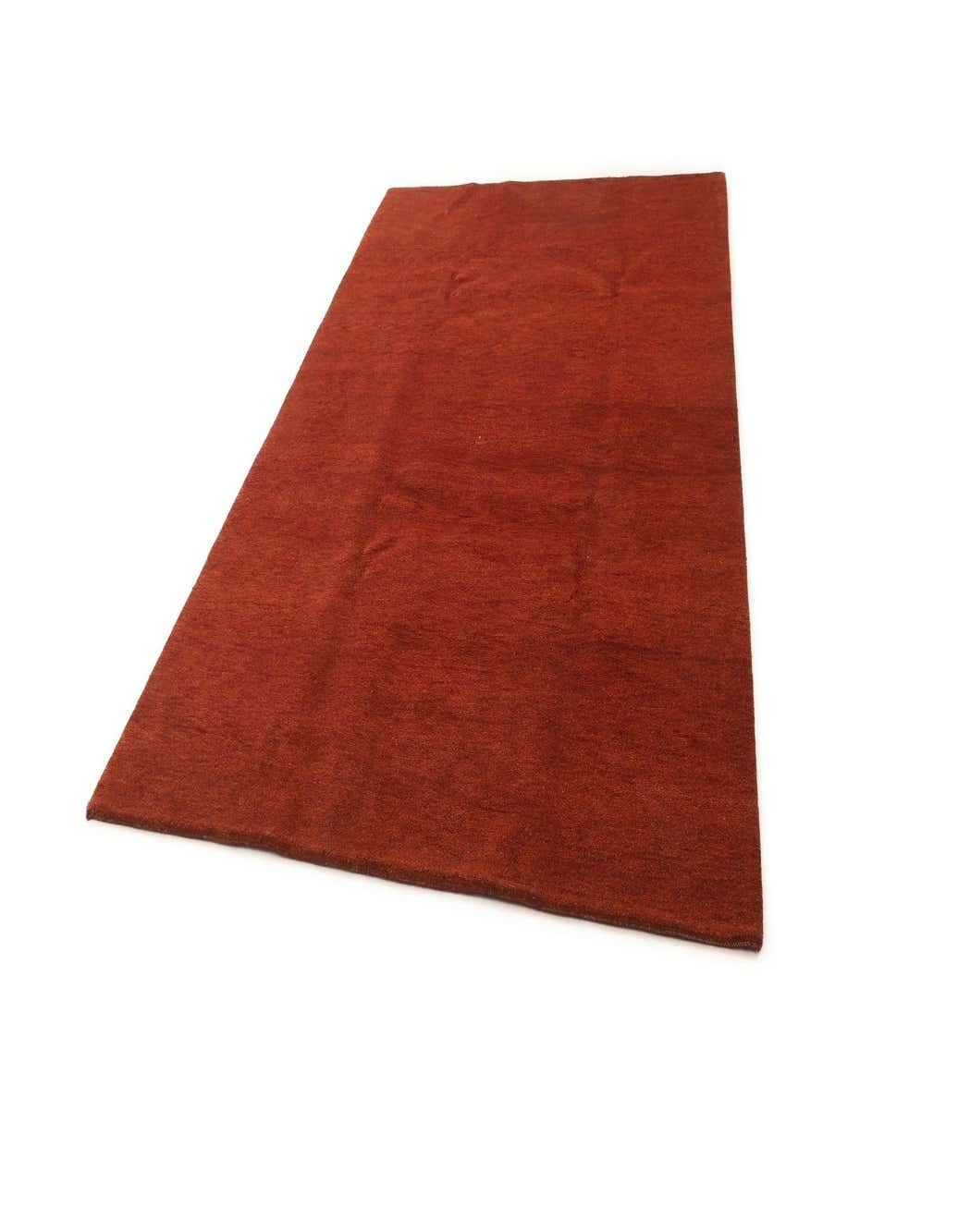 A 6x9 rectangular red wool area rug with a modern, solid design and medium pile, suitable for indoor spaces.