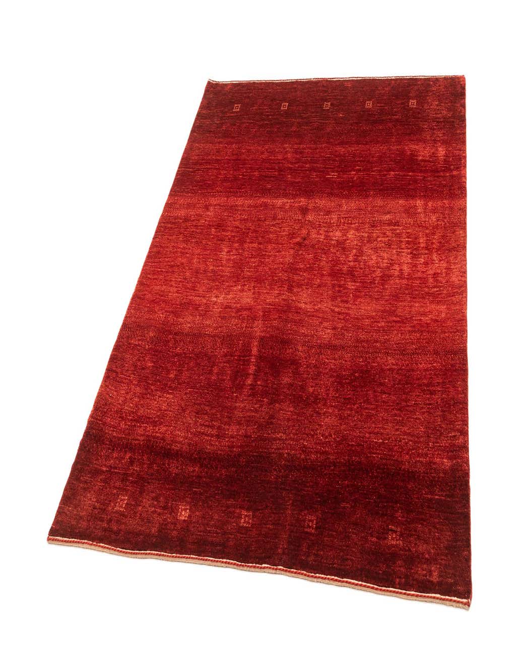 A 4x6 rectangular Gabbeh rug in varying shades of red sheep virgin wool, featuring a modern, subtly striped pattern.