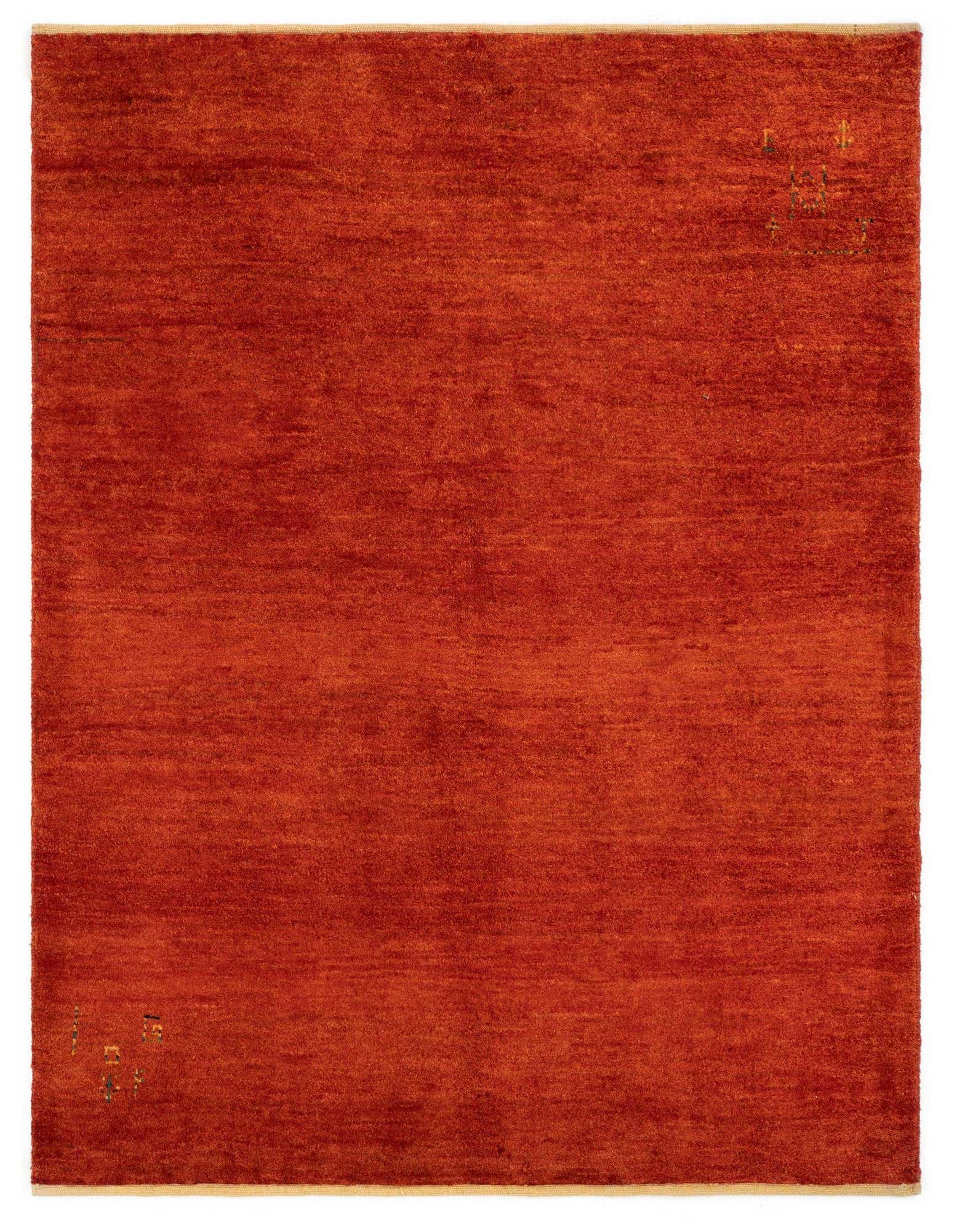 A 4x6 rectangular Gabbeh Shouli rug in rich red wool with subtle, colorful abstract accents in two corners.