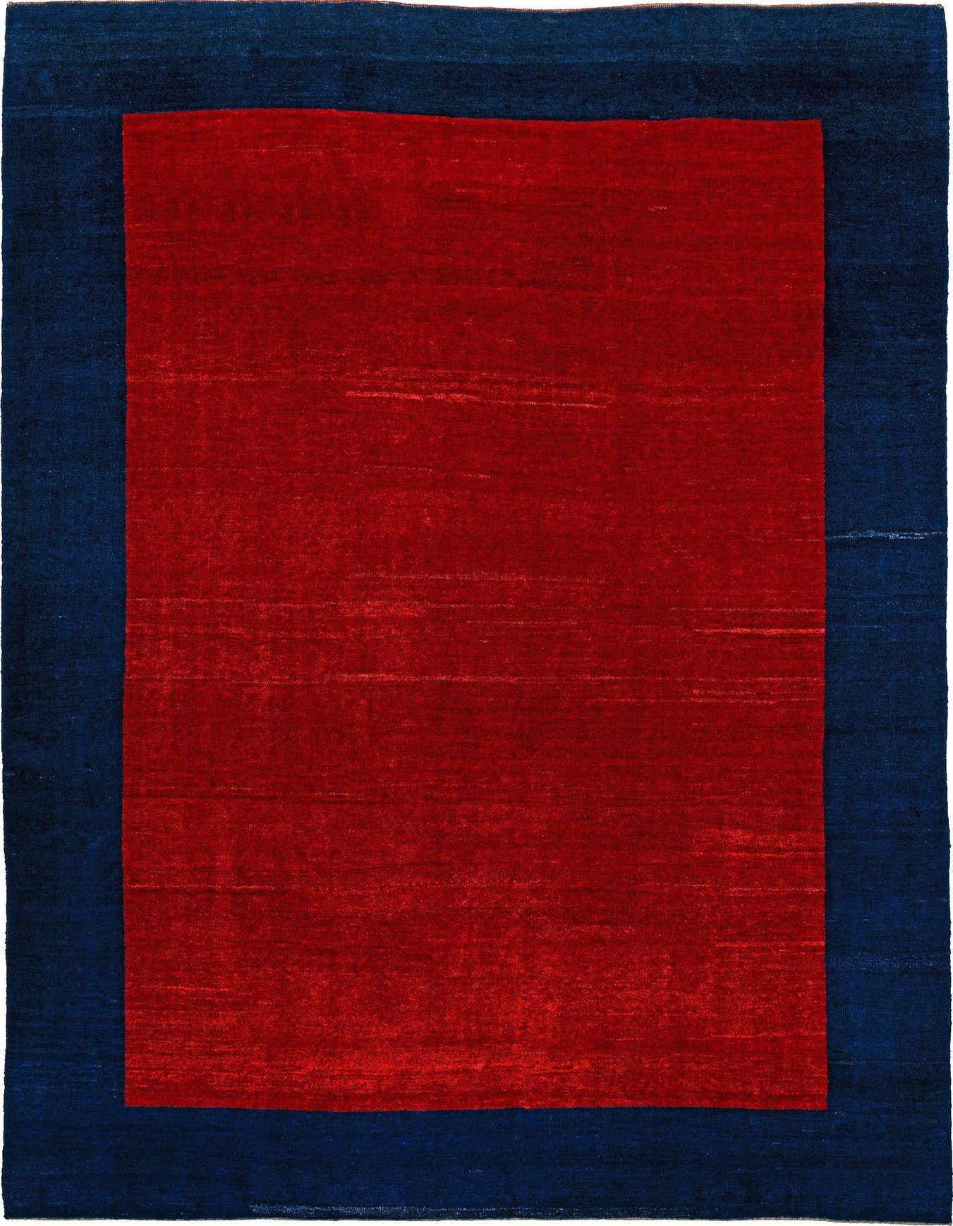 A 6x9 rectangular modern Gabbeh Shouli rug with a solid red center and a wide navy blue border.