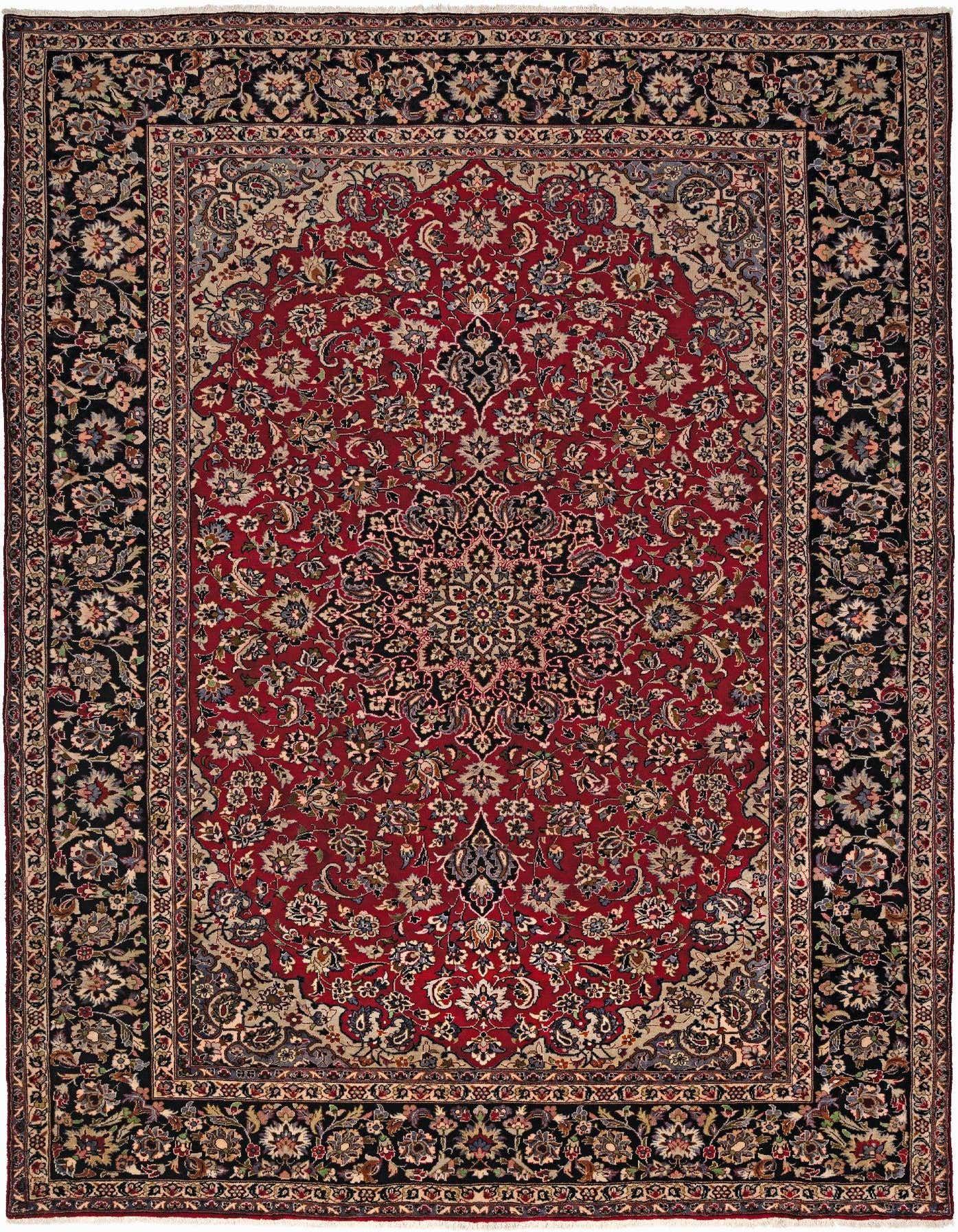 A 10x13 rectangular Isfahan rug featuring a rich red field with intricate floral patterns and a dark border.