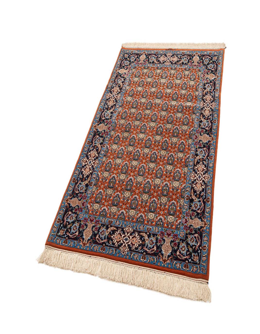 A 4x6 rectangular Isfahan rug featuring a rich red field with intricate floral patterns and a dark blue border, handmade from wool and silk.