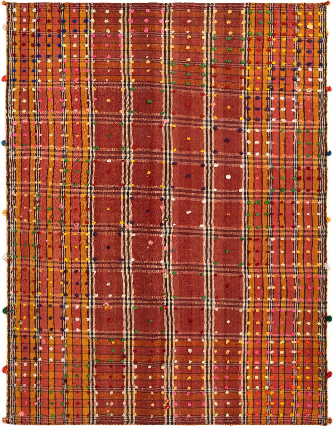 A 5x7 rectangular Jajim rug featuring a Persian plaid pattern in various reds, oranges, and yellows with colorful pom-pom accents.