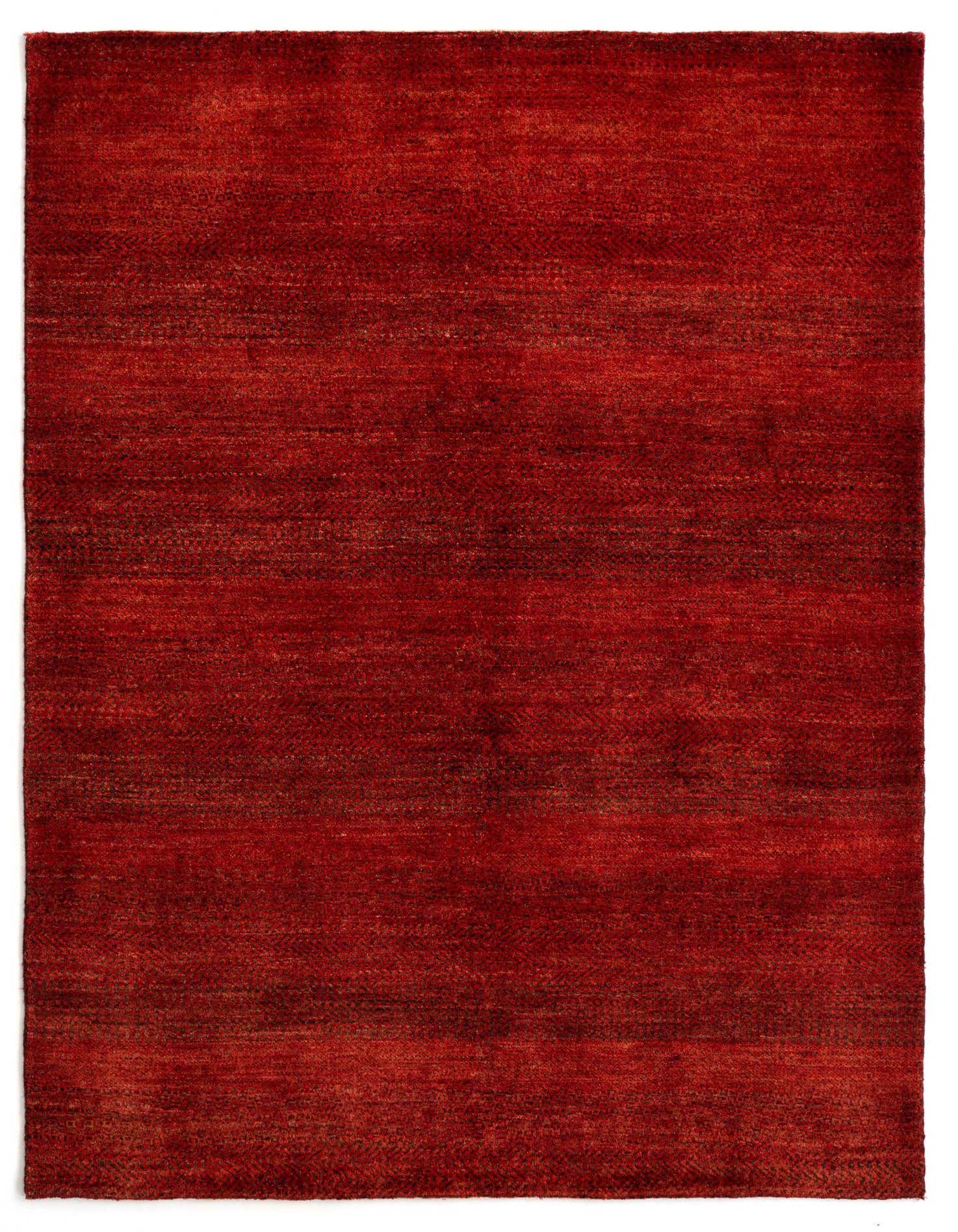 A 4x6 rectangular Juma Persian wool rug in varying shades of deep red, showcasing its medium pile and handmade texture.