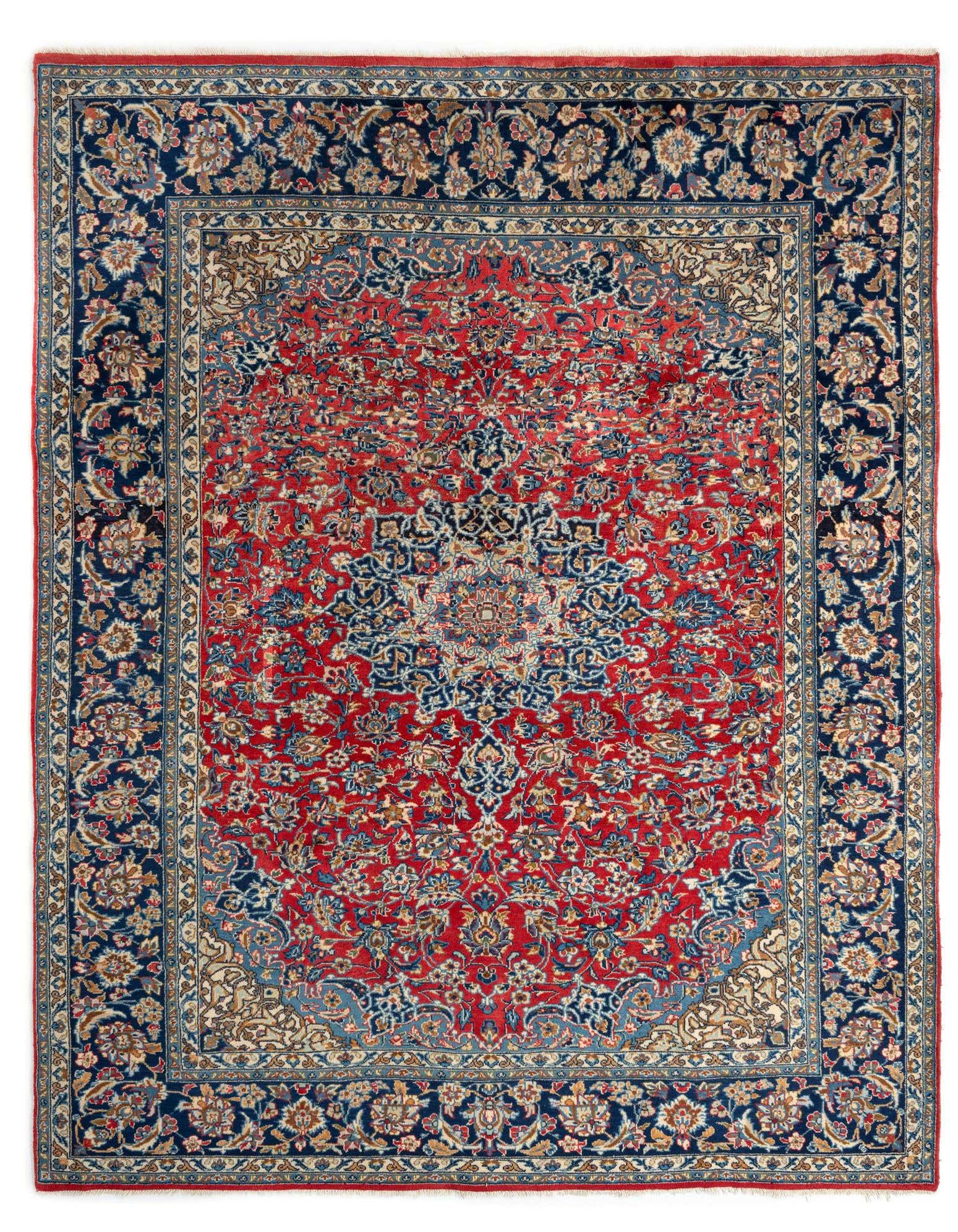 A rectangular 8x10 red Persian wool rug with intricate blue, cream, and gold floral patterns and a wide border.