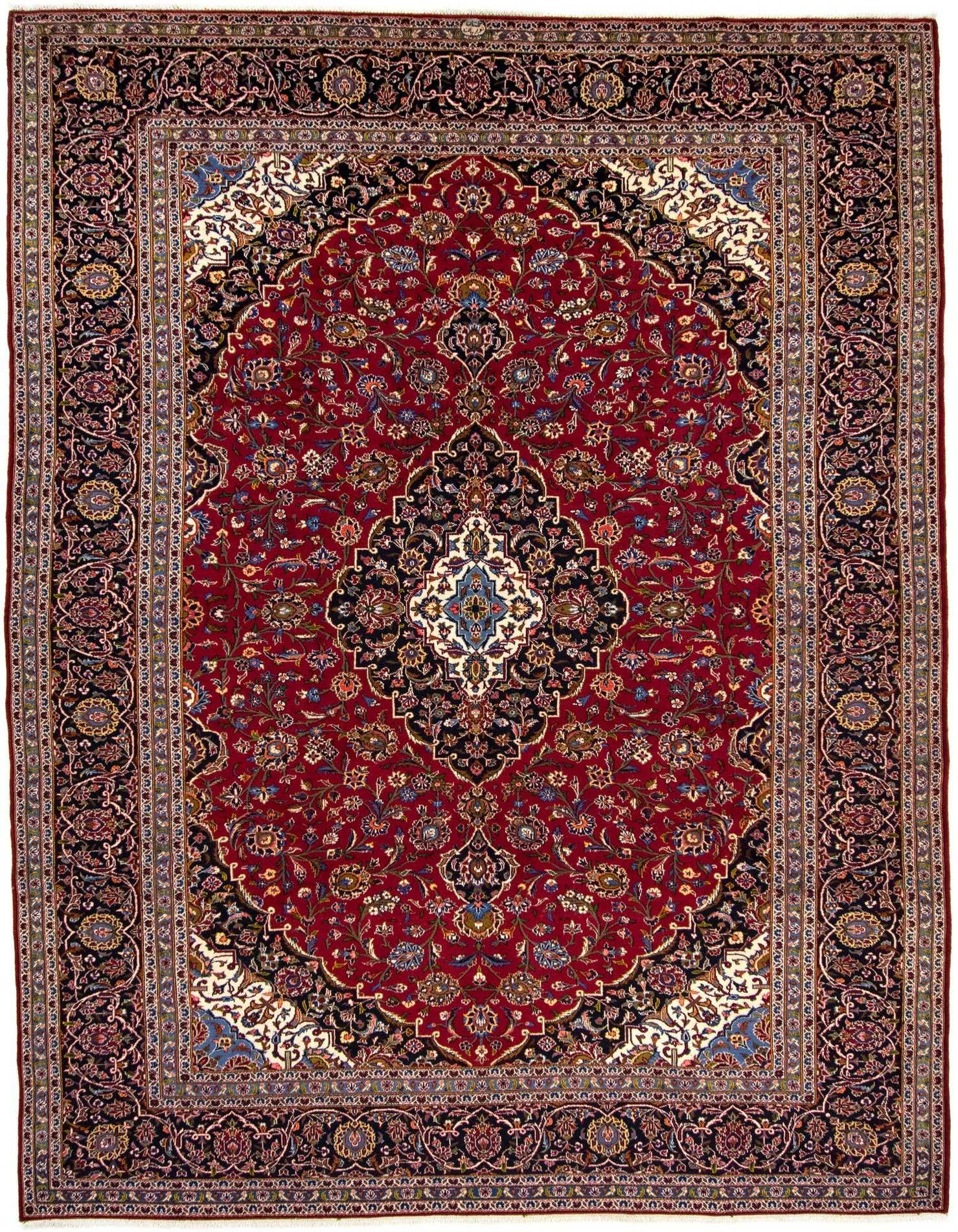 A large 10x13 rectangular red Persian wool rug with intricate floral patterns and a central medallion, featuring dark borders.