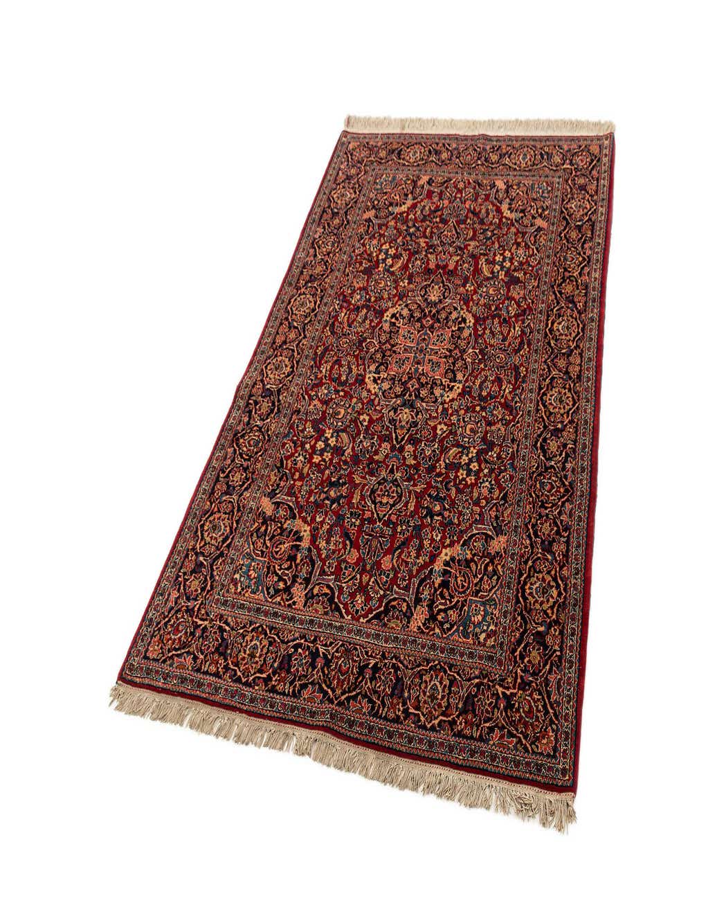 A 4x6 rectangular red area rug with an intricate traditional floral pattern and fringe ends, suitable for an entryway or living room.