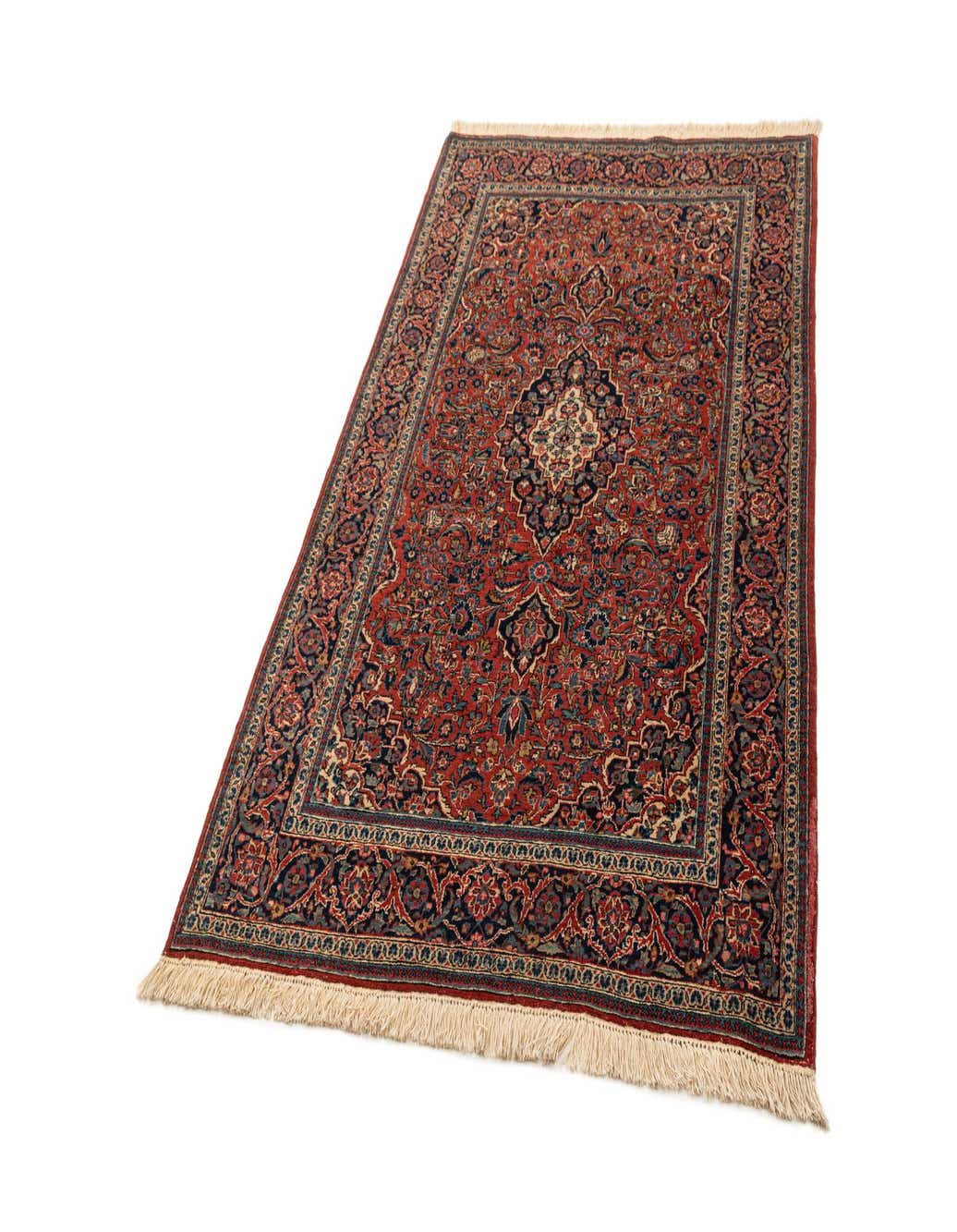 A 4x6 rectangular red area rug with intricate traditional patterns and a central medallion, featuring blue, cream, and green accents, and fringed ends.