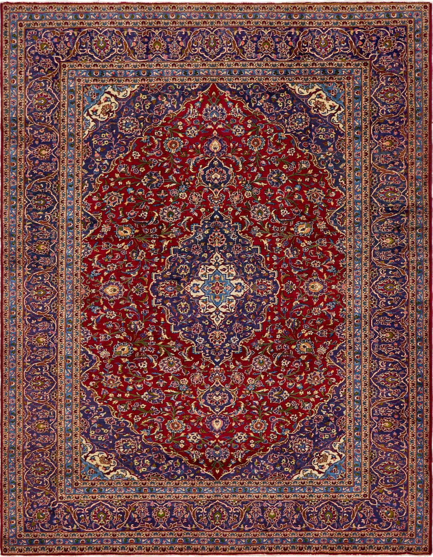 A 10x13 rectangular red Persian rug with a central medallion and intricate floral patterns in blue, gold, and cream.