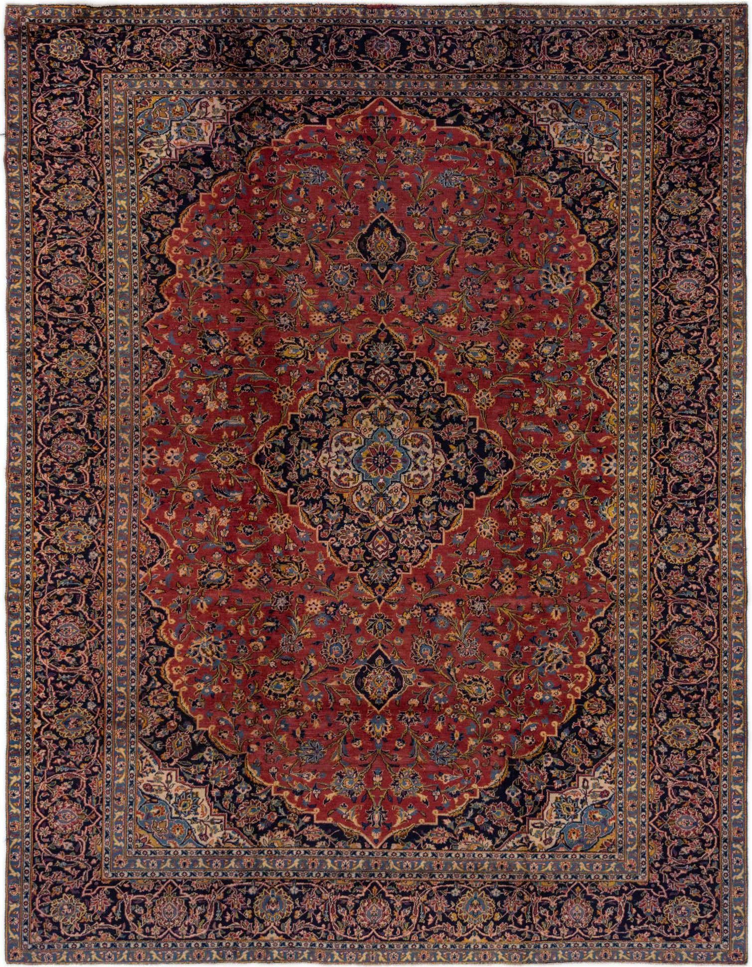 A large 10x13 rectangular red Persian rug with an intricate navy blue medallion and floral patterns, suitable for a living room.