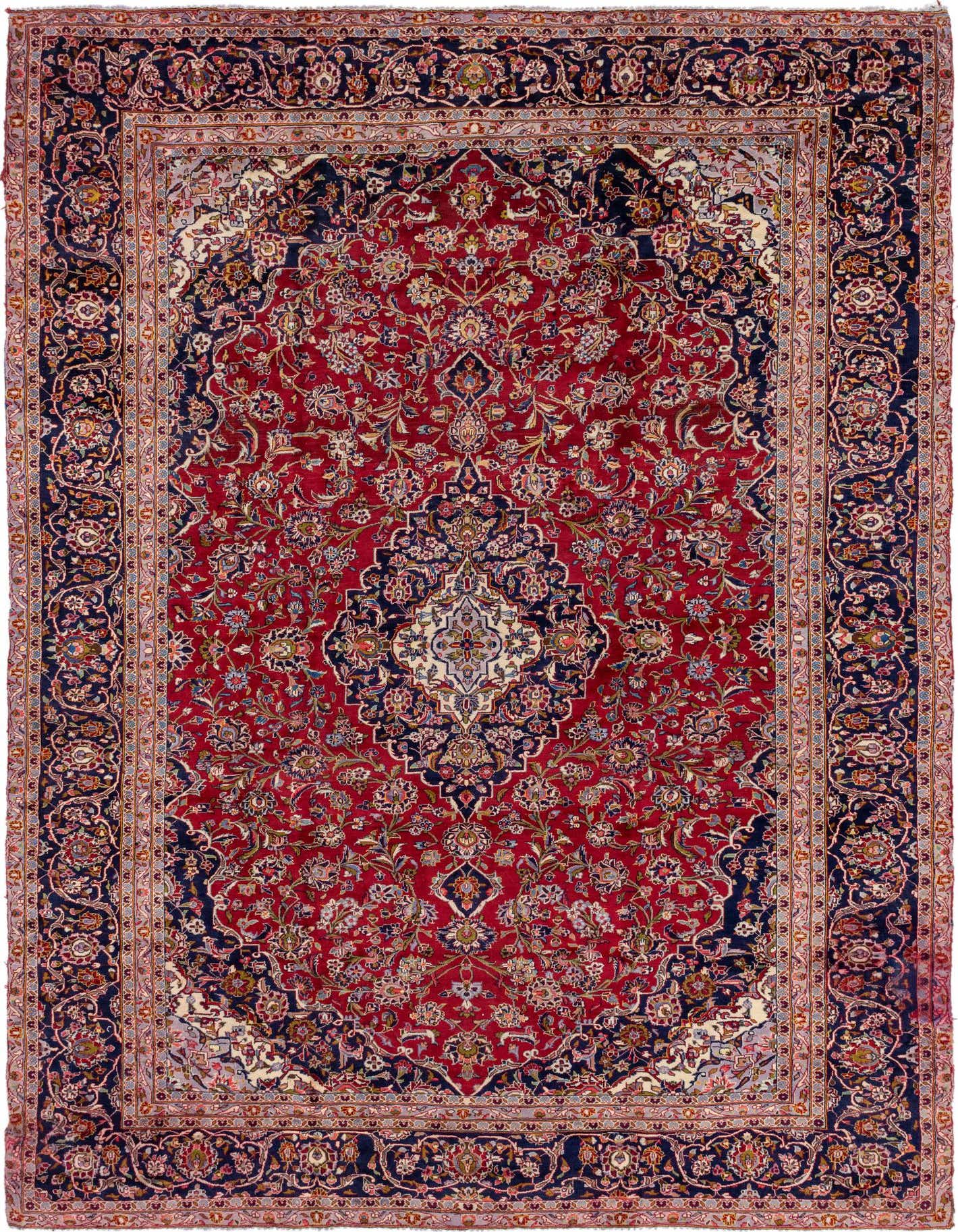 A 9x12 rectangular Kashan Persian rug with a rich red field and an ornate navy blue border, featuring intricate botanical and medallion patterns.