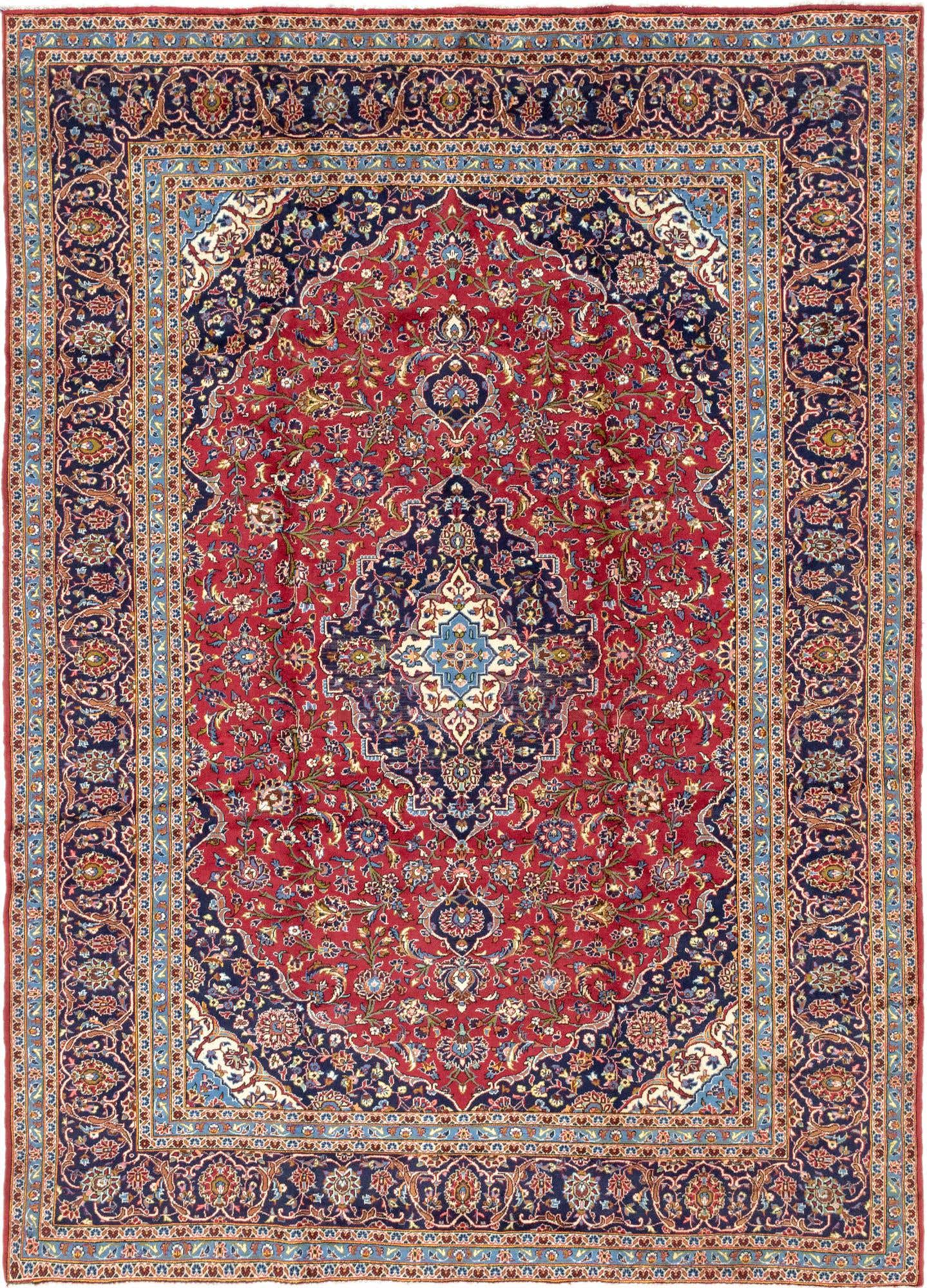A 10x13 rectangular red Persian rug with an intricate navy medallion and botanical patterns, ideal for a living room.