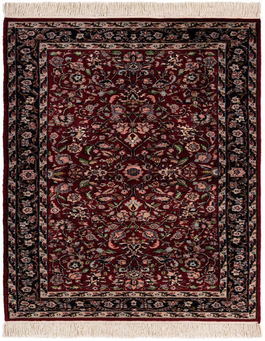 A 3x5 rectangular red traditional wool rug with an intricate floral and vine pattern, featuring a dark border and white fringe.
