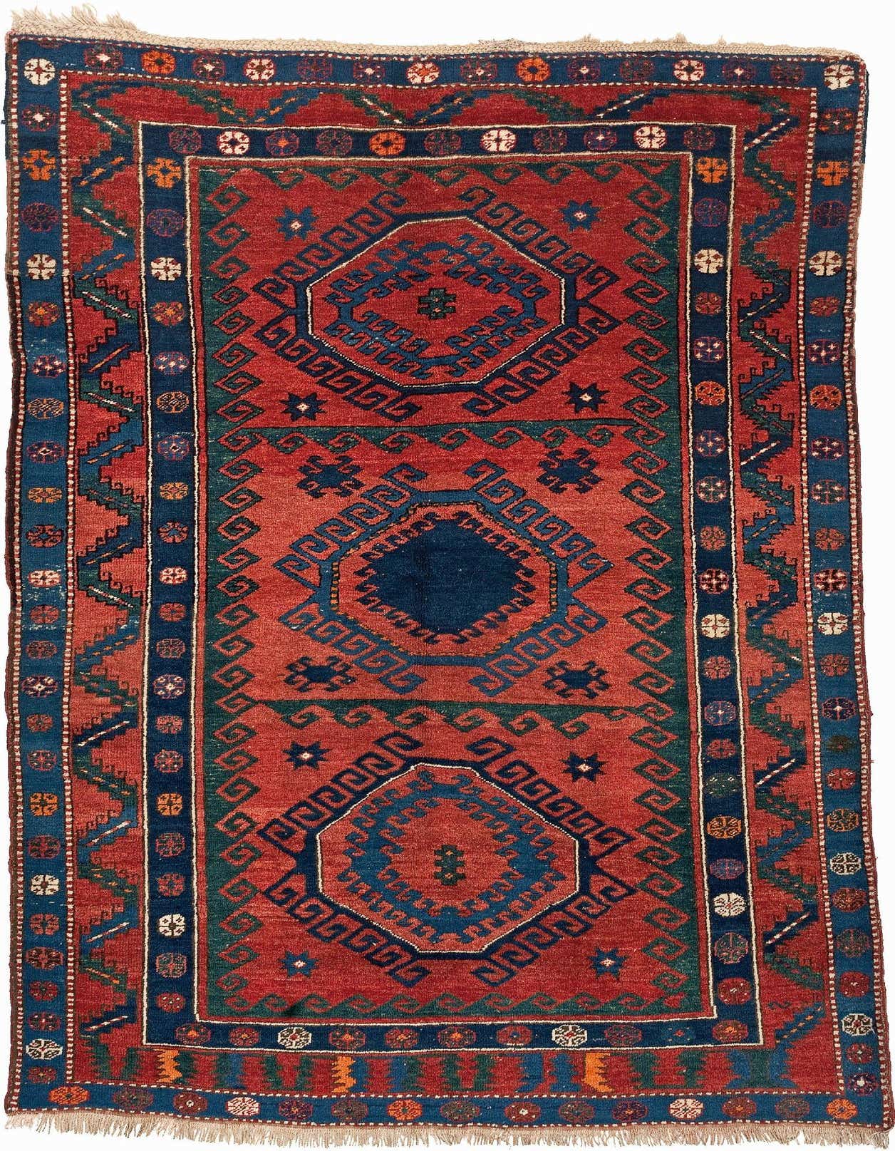 A 5x8 rectangular handmade Kazak rug in rich reds and deep blues, featuring geometric patterns and a thin pile.