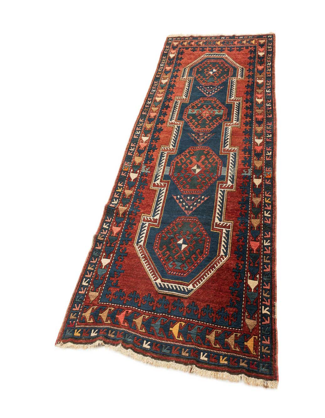 A 4x6 rectangular Kazak wool rug with a deep red field and a central navy blue medallion pattern, featuring intricate geometric designs and a thin pile.