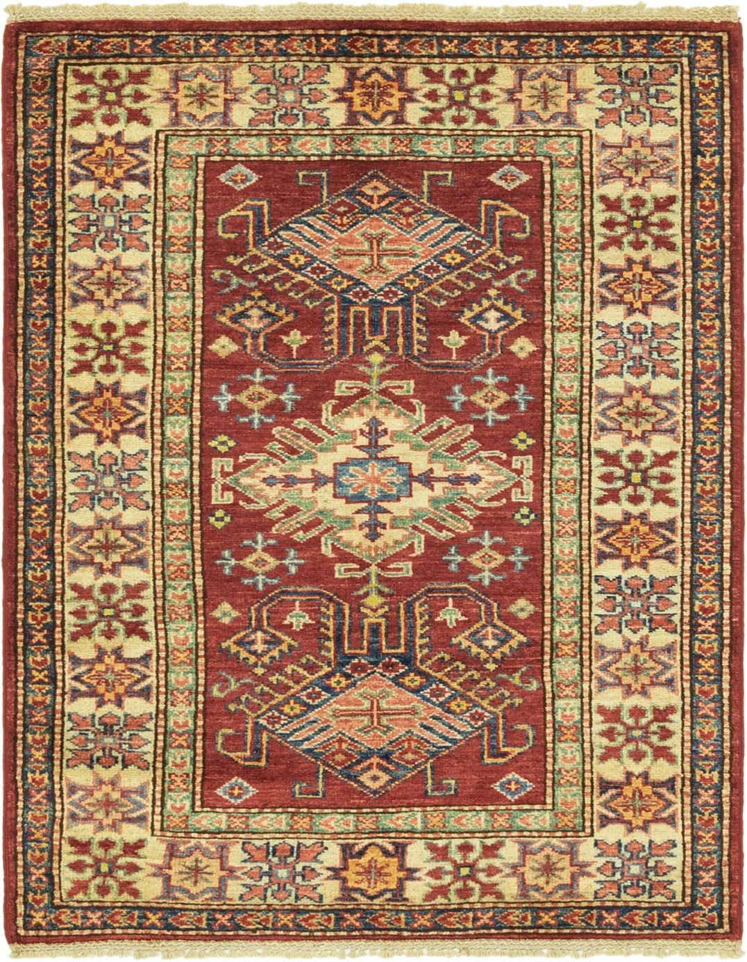 A 3x4 rectangular Rugs.com Kazak rug featuring a rich red field with intricate tribal and oriental patterns in blue, gold, and green, framed by a cream border with geometric motifs.
