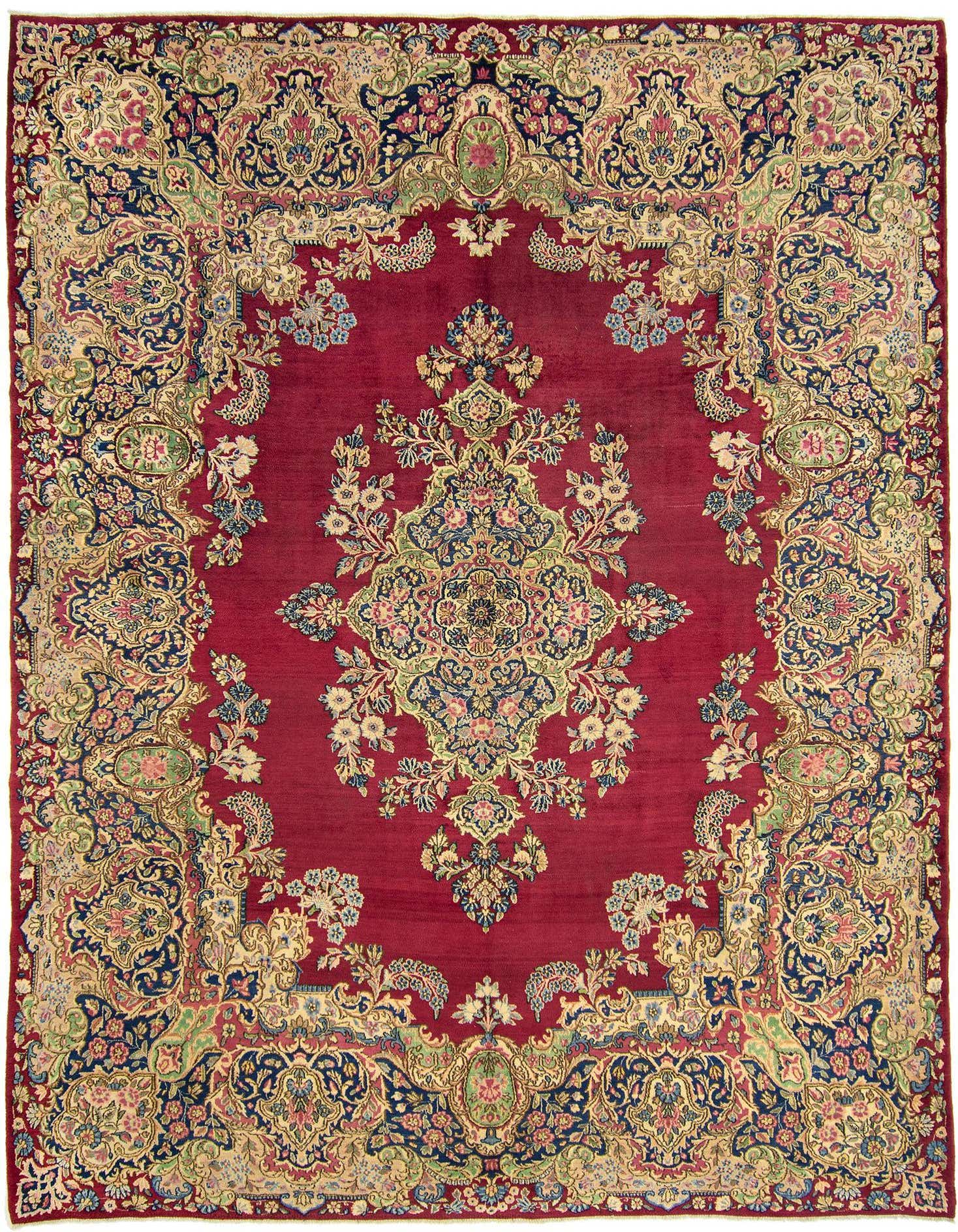 A 9x12 rectangular Kerman Persian rug in rich red with intricate floral and medallion patterns in gold, blue, and green.