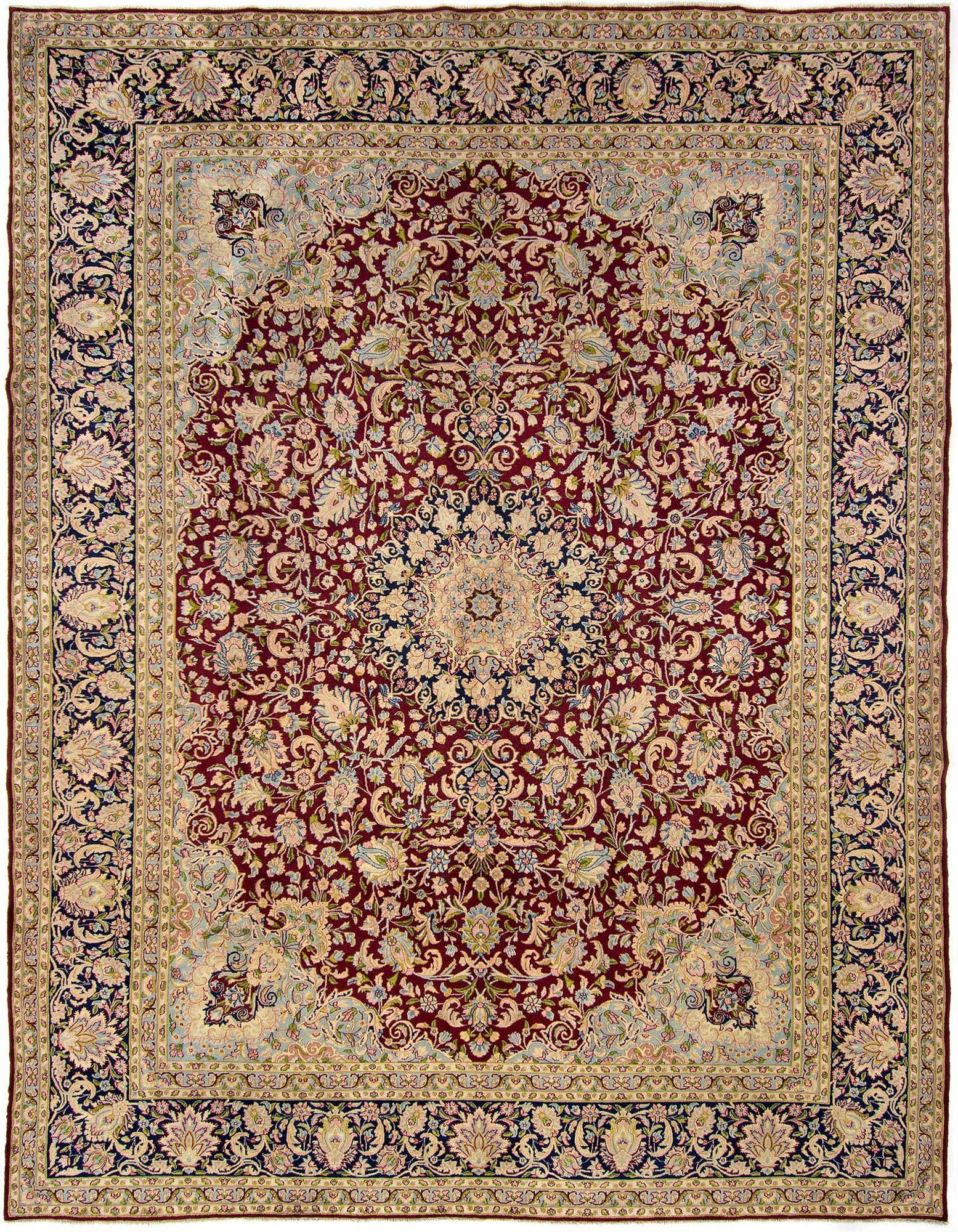A large 10x13 rectangular Kerman Persian rug featuring a rich red field with an intricate floral medallion and a multi-layered border in navy, cream, and red.
