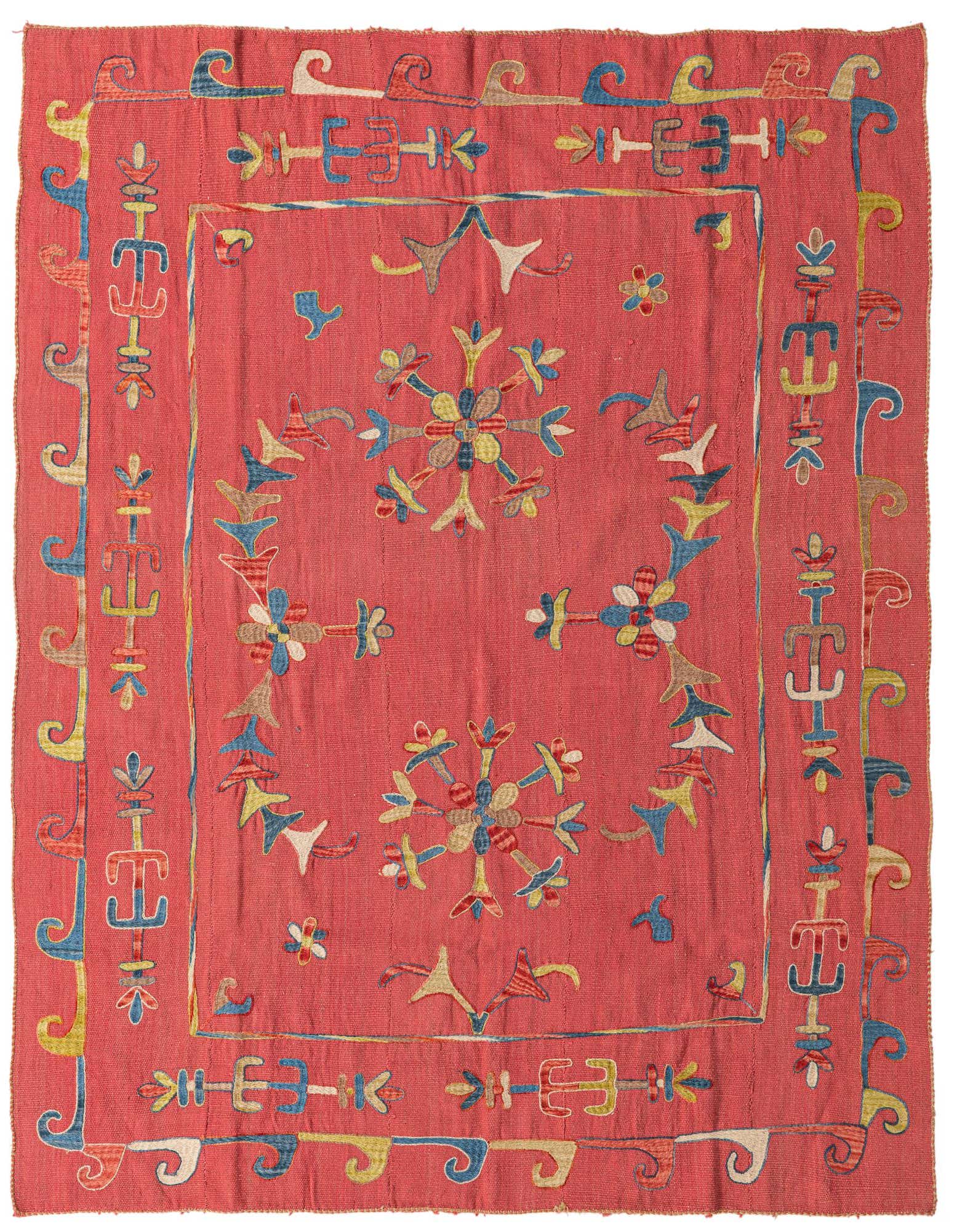 A 6x9 rectangular red tribal Kilim Suzani wool rug with intricate floral and geometric embroidery in blue, yellow, and brown.