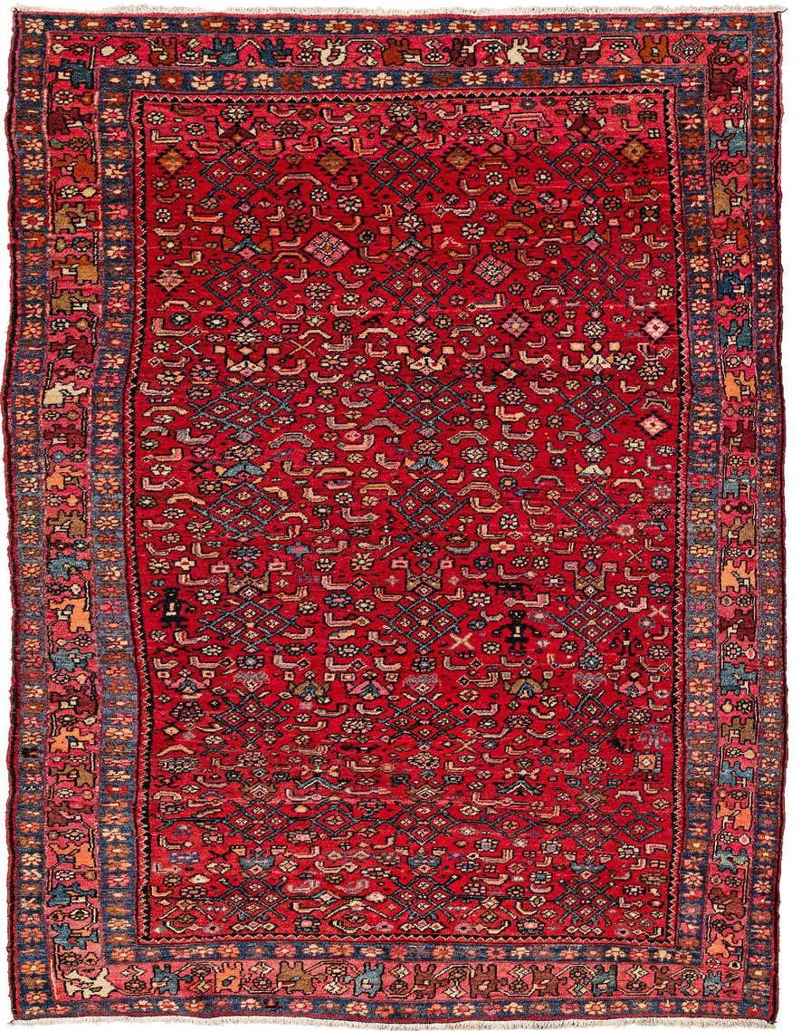 A 6x9 rectangular Koliyai rug with a vibrant red field and intricate traditional patterns in blue, gold, and cream, suitable for a living room.