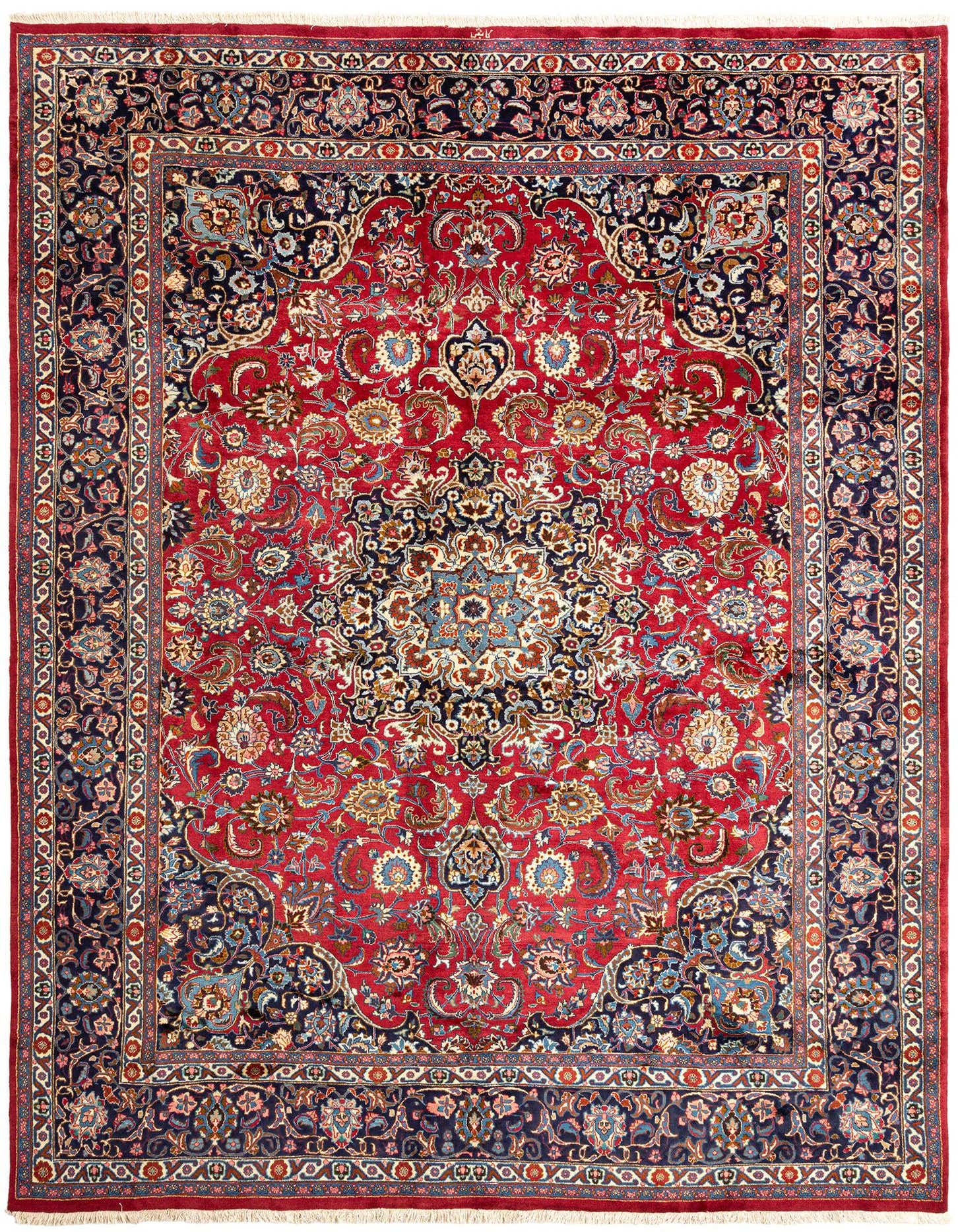 A 10x13 rectangular handmade Persian rug with a rich red field and an intricate navy blue border, featuring a detailed floral medallion pattern.