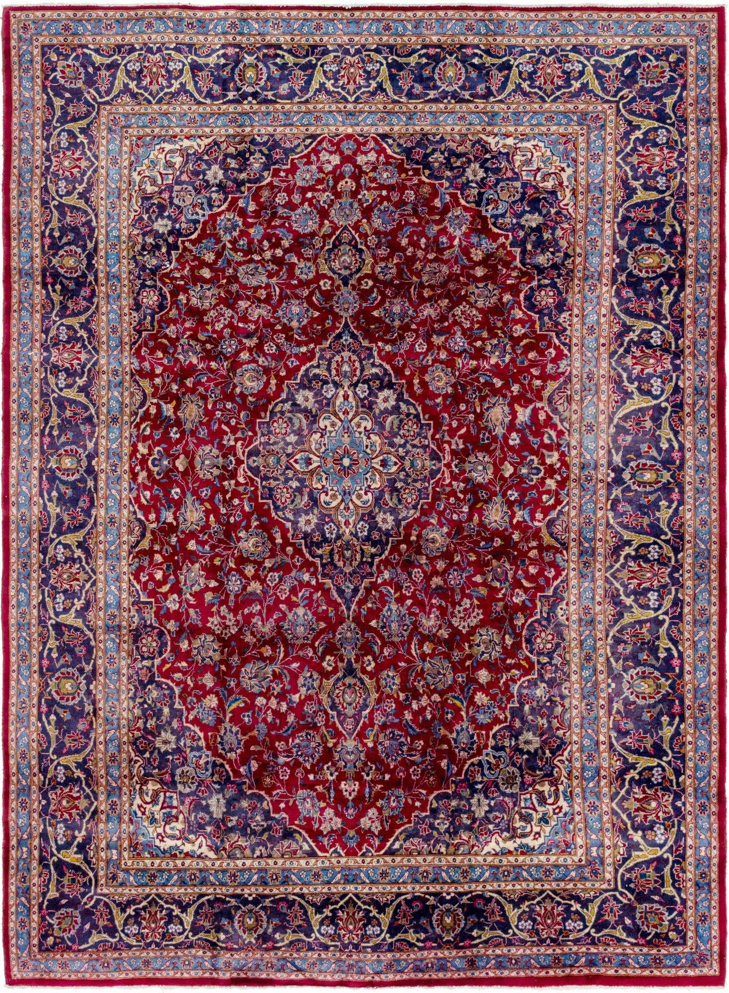 A 10x13 rectangular Mashad Persian rug with a rich red field, intricate medallion, and ornate navy blue border.