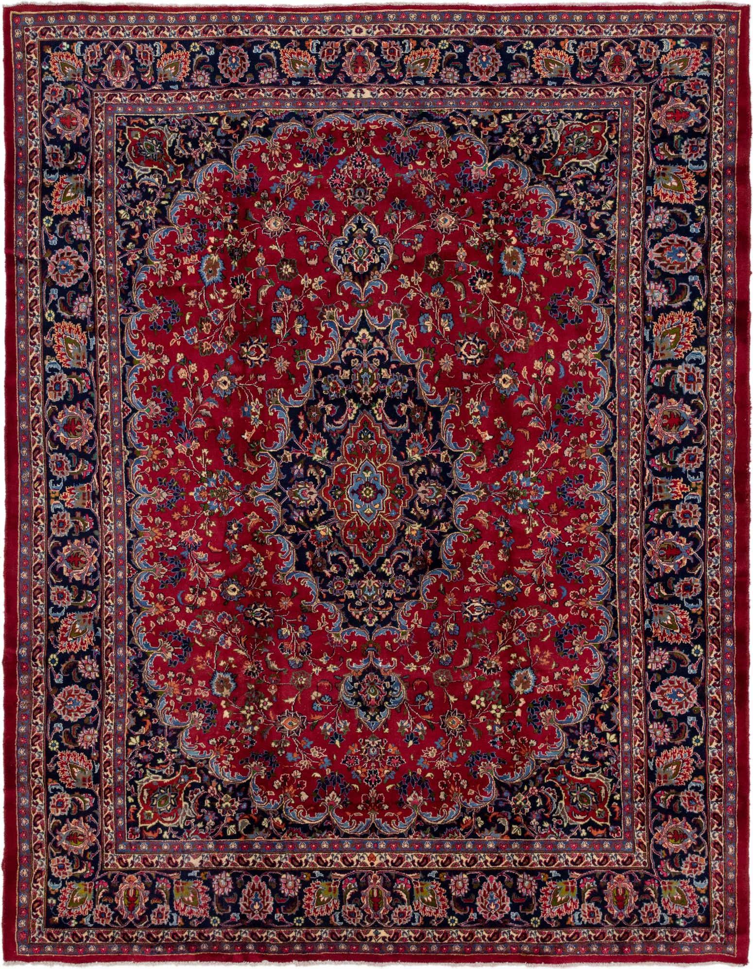A large 10x13 rectangular red Persian rug with an intricate blue medallion and floral patterns, ideal for a traditional living room.