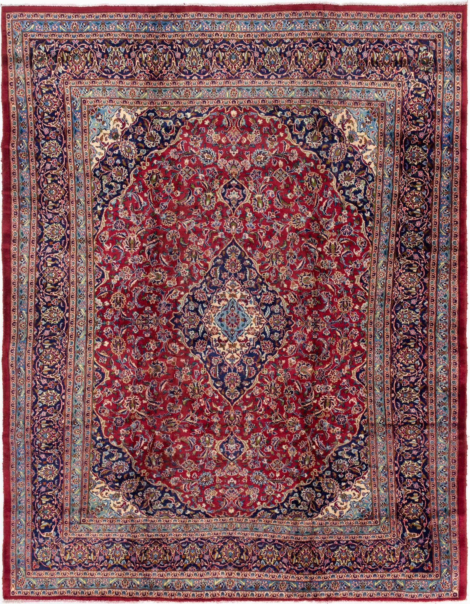 A 10x13 rectangular red Persian rug with an intricate navy blue medallion and botanical patterns, ideal for a living room.