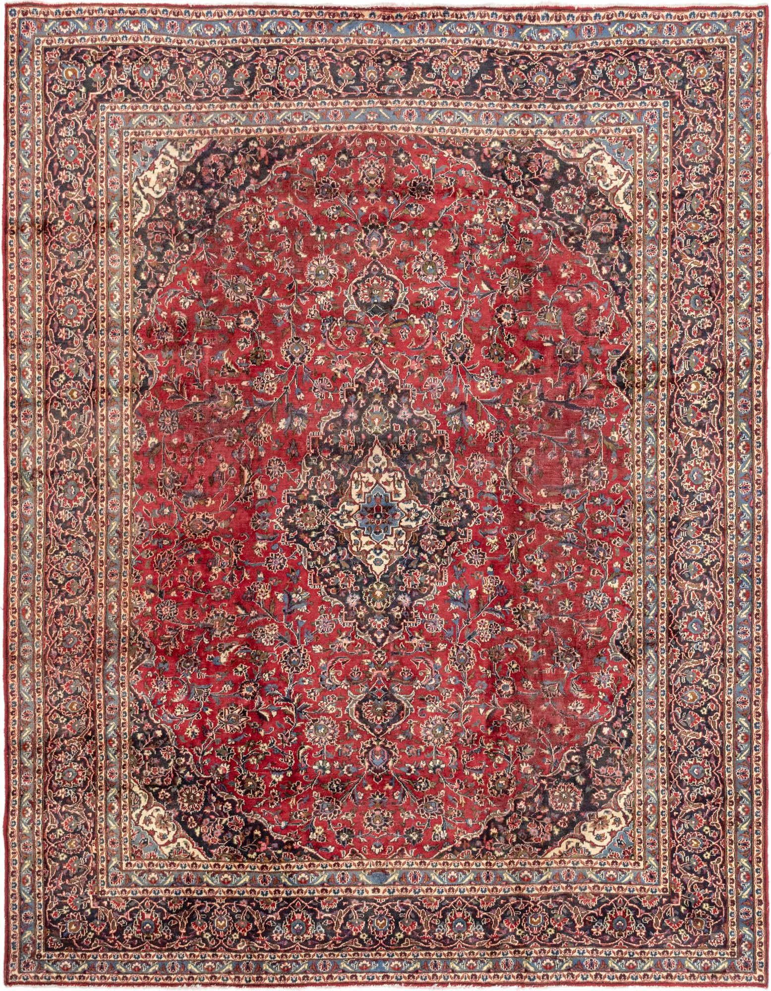 A large 10x13 rectangular red Persian rug with an intricate dark blue medallion and floral patterns, ideal for a living room.